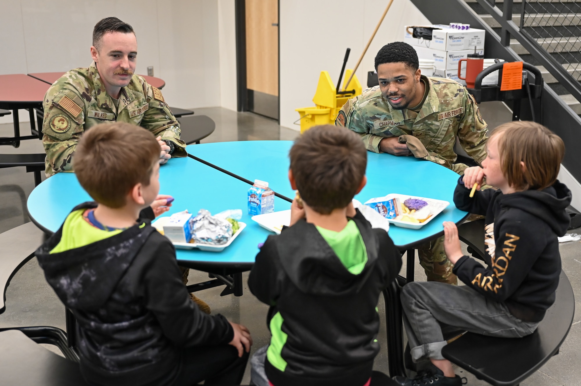 Senior Airman Blake Wilkes, 309th Aircraft Maintenance Group, and  Senior Airman Jalen Chapman, 649th Munitions Squadron, chat with South Clearfield Elementary students April 18, 2023, in Clearfield, Utah. The Airmen visited the school to engage with the community during the Month of the Military Child. (U.S. Air Force photo by Cynthia Griggs)