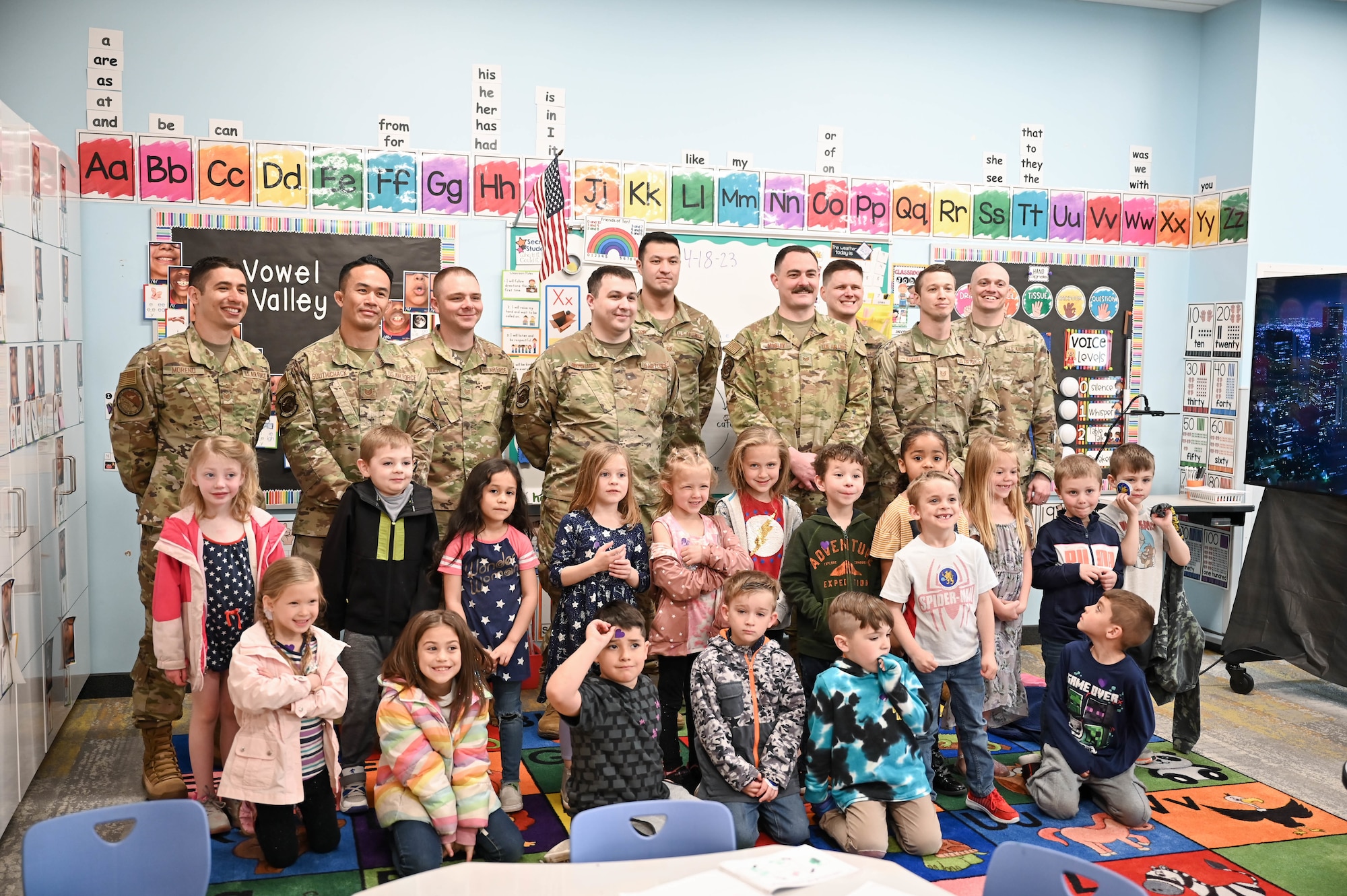 Airmen from Hill Air Force Base Airmen Leadership School pose with South Clearfield Elementary students April 18, 2023, in Clearfield, Utah. The Airmen visited the school to engage with the community during the Month of the Military Child. (U.S. Air Force photo by Cynthia Griggs)