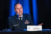 Man in uniform speaking into microphone