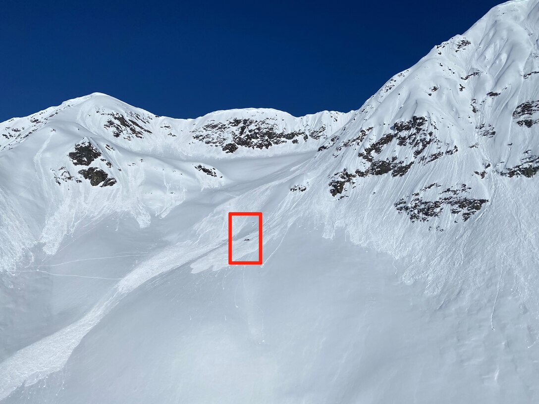 On April 19, 2023, an avalanche broke loose at the top of a mountain near Girdwood, Alaska, pulling a backcountry skier 800 to 1000 feet down the face. The red box indicates the injured skier and rescue team. The Alaska Army National Guard’s Golf Company, 2-211th General Aviation Support Battalion received mission request from the Alaska Rescue Coordination Center and rescued the skier with a hoist-capable HH-60M Black Hawk helicopter specially designed for medical evacuations.