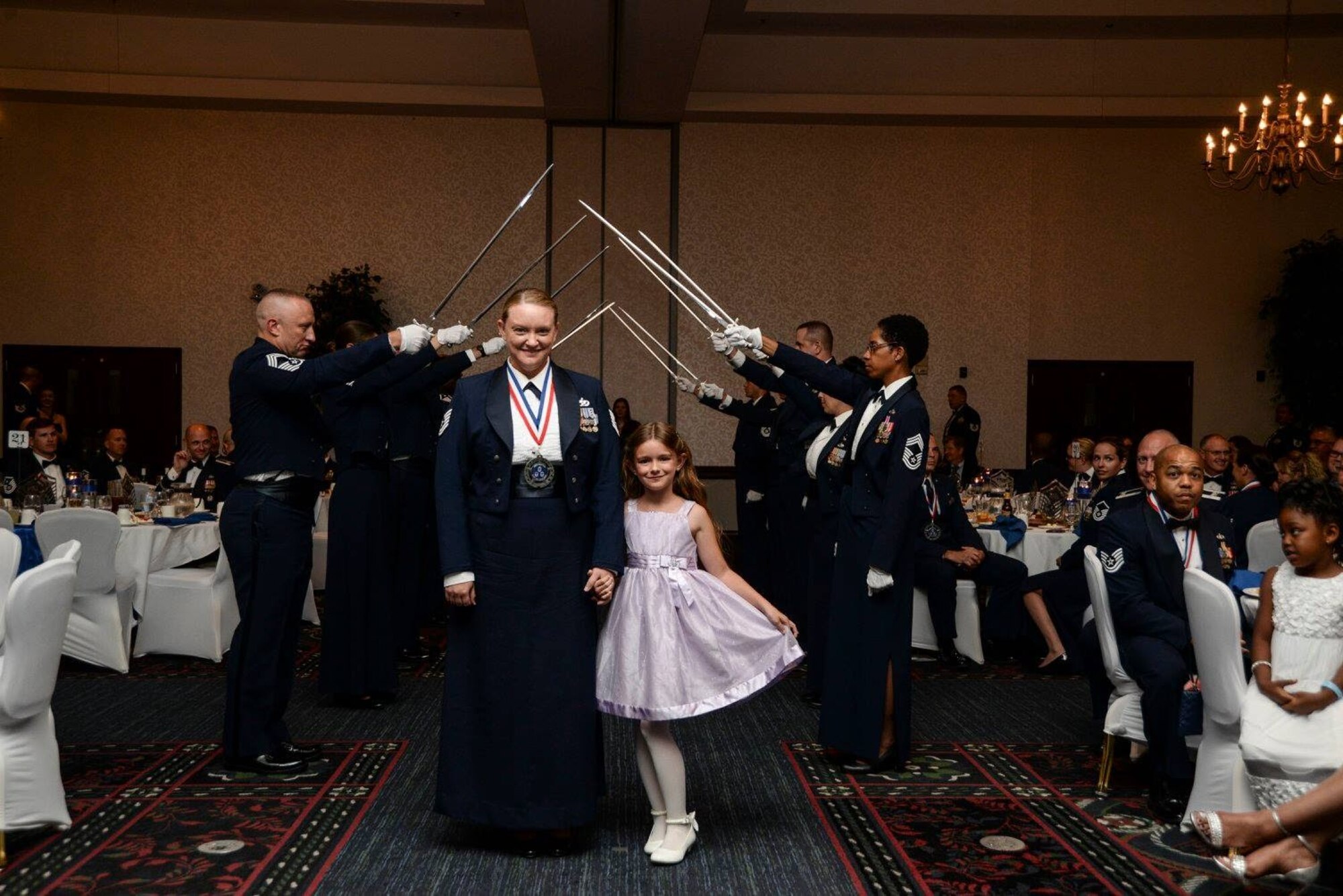 Master Sgt. Krystle Lindamood, 647th Civil Engineer Squadron first sergeant, and Genevieve, her daughter, attend a senior induction ceremony. Lindamood, a fourth-generation military child, shared moments of her childhood, highlighting the challenges children experience living with a parent who serves in the military. These challenges can include deployment, transitioning schools and making new friends. (Courtesy photo)