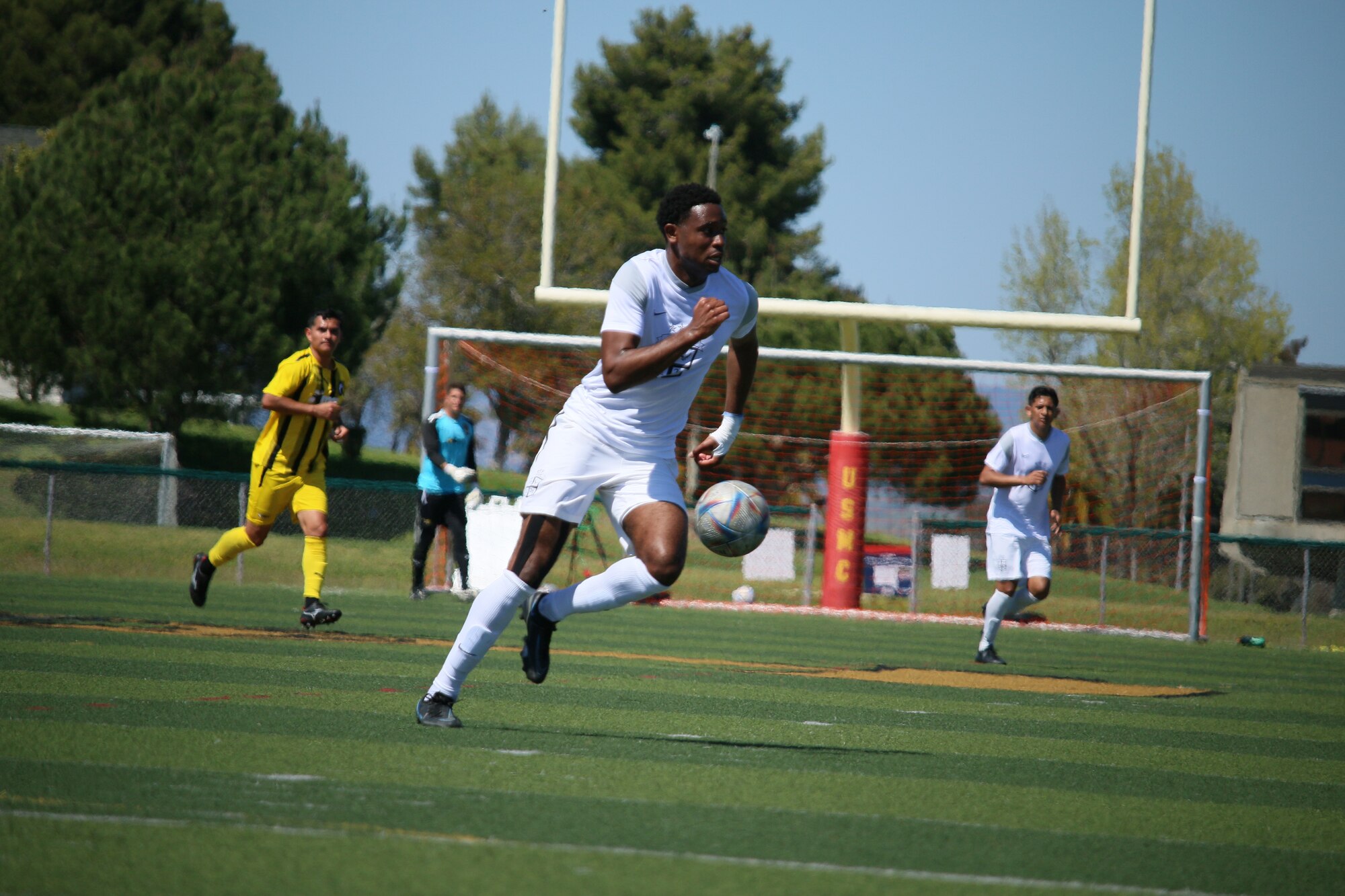 Player in white uniform plays with the ball