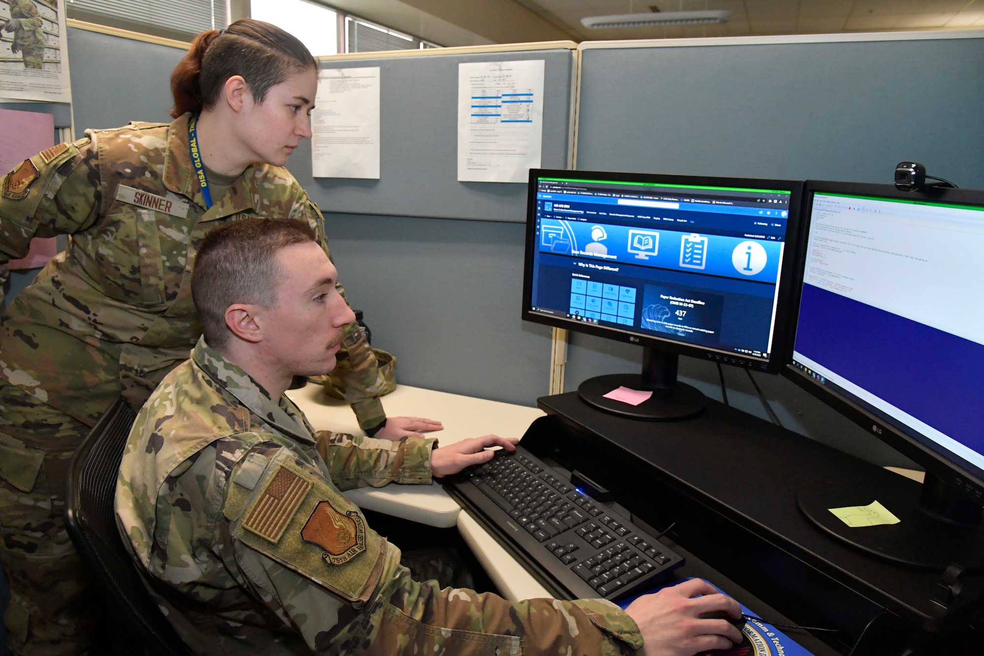 (Seated) Senior Airman Brandon Tankersley, and Airman 1st Class Jenna Skinner, both 75th Air Base Wing, information, and communications directorate, display a new electronic records management system, April 20, 2023, at Hill Air Force Base, Utah. (US Photo by Todd Cromar)