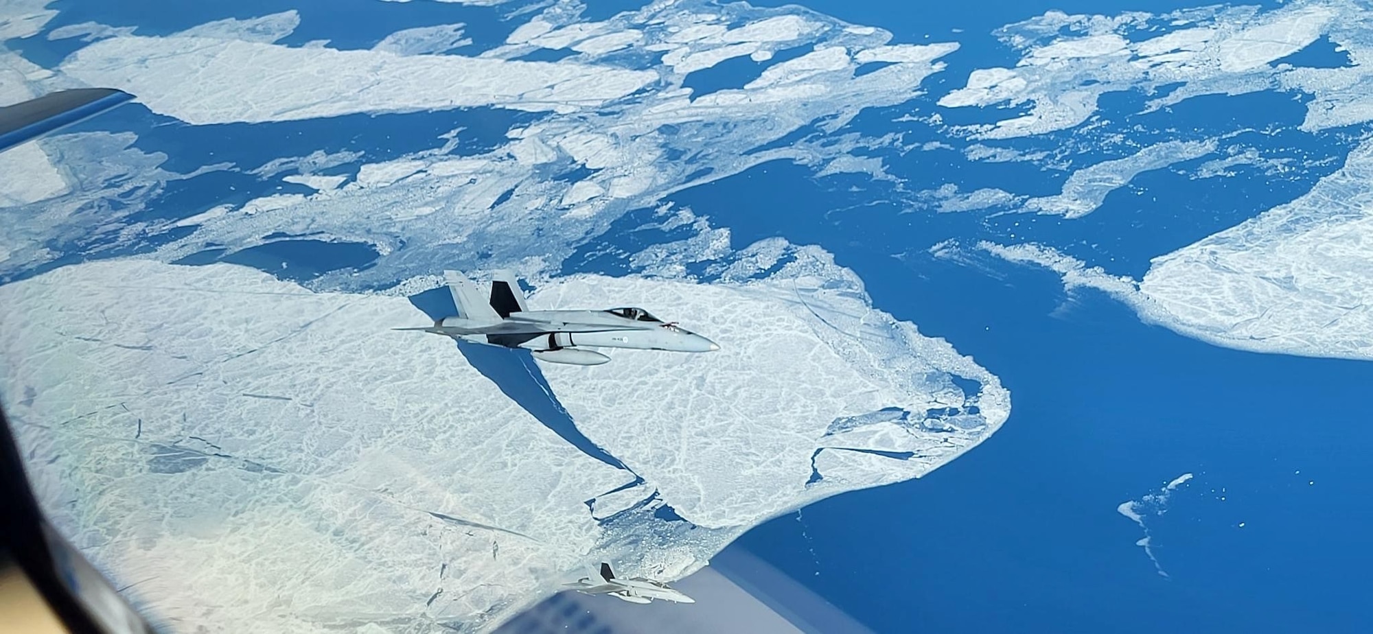 From the cockpit, a U.S. KC-46A Pegasus tanker aircraft from the Air Force Reserve Command’s 931st Air Refueling Wing, primarily stationed at McConnell Air Force Base, Kansas, refuels Finnish F/A-18s, April 13, 2023.