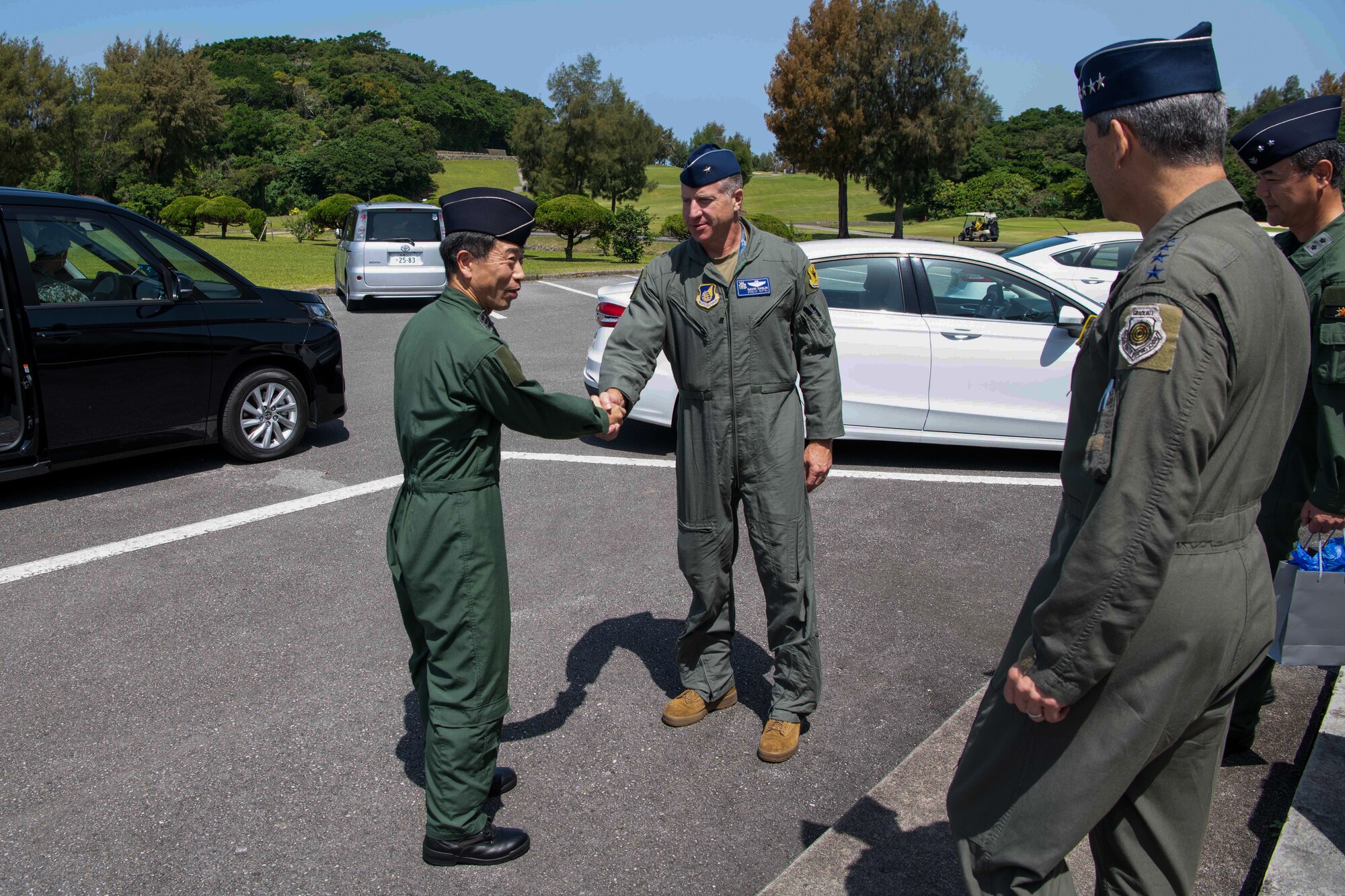 U.S. Air Force Brig. Gen. Dave Eaglin, 18th Wing commander, shakes hands with Japan Air Self-Defense Force Lt. Gen. Masahito Yajima, Southwestern Air Defense Force commander, at Kadena Air Base, Japan, April 16, 2023. Cooperation among Allies and partners is critical in deterring aggression and enhancing interoperability allowing our forces to counter military aggression by sharing responsibilities for common defense. (U.S. Air Force photo by Airman 1st Class Jonathan R. Sifuentes)
