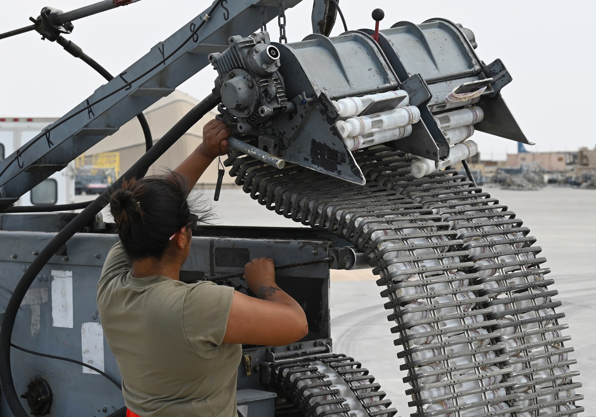 U.S. Air Force Airman 1st Class Serena Mena, 75th Expeditionary Fighter Generation Squadron weapons load crew member, prepares an ammunition loader prior to loading rounds into a U.S. Air Force A-10 Thunderbolt II at Al Dhafra Air Base, United Arab Emirates, April 18, 2022. The loading of these munitions represents another step forward in the deployment of the A-10 to the U.S. Central Command area of responsibility, which offers the opportunity for 9th Air Force (Air Forces Central). to experiment with CAS capabilities in order to achieve the most robust, diverse force possible. Ninth AF (AFCENT) is committed to ensuring security and stability alongside our partners in the U.S. Central Command area of responsibility. (U.S. Air Force photo by Tech. Sgt. Alex Fox Echols III)