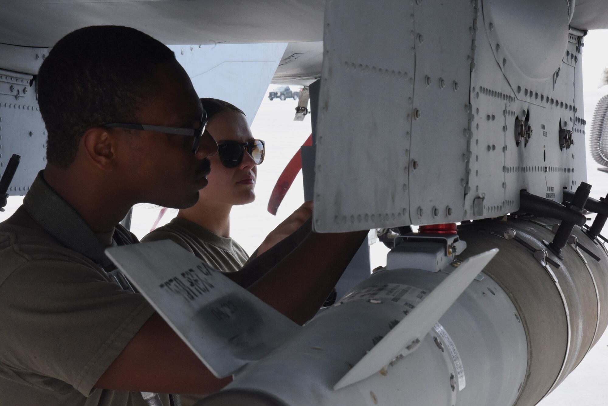 U.S. Air Force Staff Sgt. Brian Dorsey, and Senior Airman Reese Deandrea, 75th Expeditionary Fighter Generation Squadron weapons crew chiefs, load munitions on the first live-fire A-10 Thunderbolt II sortie at Al Dhafra Air Base, United Arab Emirates, April 18, 2023. The loading of these munitions represents another step forward in the deployment of the A-10 to the U.S. Central Command area of responsibility, which offers the opportunity for 9th Air Force (Air Forces Central). to experiment with CAS capabilities in order to achieve the most robust, diverse force possible. Ninth AF (AFCENT) is committed to ensuring security and stability alongside our partners in the U.S. Central Command area of responsibility. (U.S. Air Force photo by Tech. Sgt. Chris Jacobs/released)