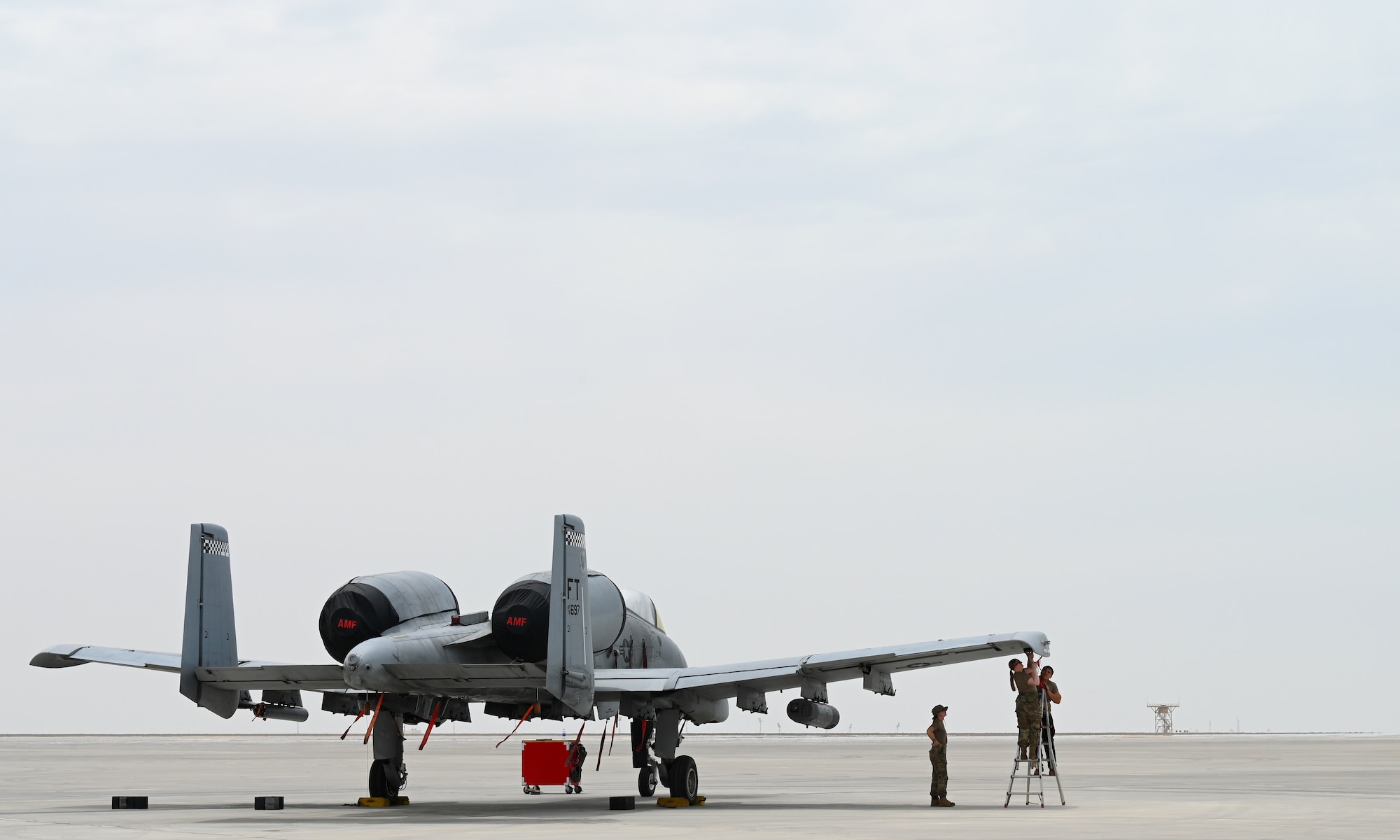 U.S. Air Force Airmen from the 75th Expeditionary Fighter Generation Squadron prepare a U.S. Air Force A-10 Thunderbolt II for a munitions load at Al Dhafra Air Base, United Arab Emirates, April 18, 2022. The loading of these munitions represents another step forward in the deployment of the A-10 to the U.S. Central Command area of responsibility, which offers the opportunity for 9th Air Force (Air Forces Central). to experiment with CAS capabilities in order to achieve the most robust, diverse force possible. Ninth AF (AFCENT) is committed to ensuring security and stability alongside our partners in the U.S. Central Command area of responsibility.  (U.S. Air Force photo by Tech. Sgt. Alex Fox Echols III)