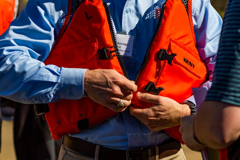 Joseph Savage, with the U.S. Army Corps of Engineers Great Lakes and Ohio River Division, zips up a life jacket along with members of the Inland Waterways Users Board for a tour of the Monongahela River Locks and Dam 4 at Charleroi, Pennsylvania, April 12, 2023.

The U.S. Army Corps of Engineers Pittsburgh District hosted the tour and several briefings about ongoing and future inland navigation construction projects within the district.

During the tour, Inland Waterways User Board (IWUB) members learned about the overall Lower Monongahela River navigation project and the new river chamber construction at Charleroi, which is in its final phase after nearly 20 years of construction. Members also listened to briefings about the overall Upper Ohio navigation project and its first major construction contract, the new Montgomery lock construction. 

IWUB is an industry federal-advisory committee representing all fuel-taxed inland waterway systems within the United States. The navigation industry contributes to the Inland Waterways Trust Fund through fuel taxes paid by carriers who transport bulk commodities on the inland waterway system. The board makes recommendations to Congress and the Assistant Secretary of the Army for Civil Works on how best to invest federal and trust funds dollars to keep the most cost-effective, environmentally friendly, and safest form of transportation for bulk commodities resilient and reliable.
(U.S. Army Corps of Engineers Pittsburgh District photo by Michel Sauret)