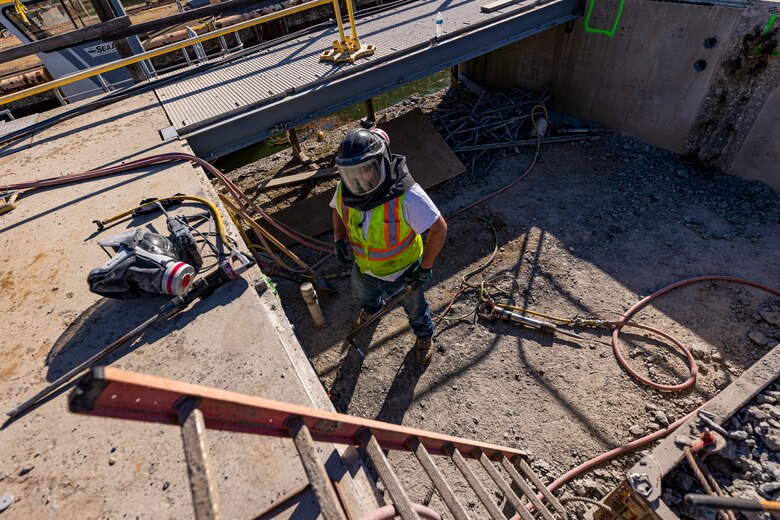Matt Wilson, a laborer, uses a torch to cut off rebar protruding out of a concrete wall at a construction site for the new river chamber at the Monongahela River Locks and Dam 4 in Charleroi, Pennsylvania, April 12, 2023.

The U.S. Army Corps of Engineers Pittsburgh District hosted the tour and several briefings about ongoing and future inland navigation construction projects within the district.

During the tour, Inland Waterways User Board (IWUB) members learned about the overall Lower Monongahela River navigation project and the new river chamber construction at Charleroi, which is in its final phase after nearly 20 years of construction. Members also listened to briefings about the overall Upper Ohio navigation project and its first major construction contract, the new Montgomery lock construction. 

IWUB is an industry federal-advisory committee representing all fuel-taxed inland waterway systems within the United States. The navigation industry contributes to the Inland Waterways Trust Fund through fuel taxes paid by carriers who transport bulk commodities on the inland waterway system. The board makes recommendations to Congress and the Assistant Secretary of the Army for Civil Works on how best to invest federal and trust funds dollars to keep the most cost-effective, environmentally friendly, and safest form of transportation for bulk commodities resilient and reliable.
(U.S. Army Corps of Engineers Pittsburgh District photo by Michel Sauret)