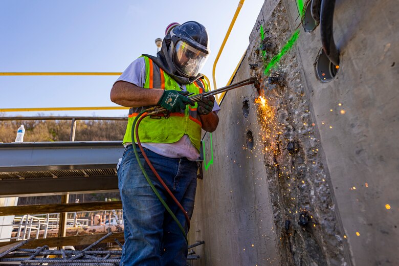 Matt Wilson, a laborer, uses a torch to cut off rebar protruding out of a concrete wall at a construction site for the new river chamber at the Monongahela River Locks and Dam 4 in Charleroi, Pennsylvania, April 12, 2023.

The U.S. Army Corps of Engineers Pittsburgh District hosted the tour and several briefings about ongoing and future inland navigation construction projects within the district.

During the tour, Inland Waterways User Board (IWUB) members learned about the overall Lower Monongahela River navigation project and the new river chamber construction at Charleroi, which is in its final phase after nearly 20 years of construction. Members also listened to briefings about the overall Upper Ohio navigation project and its first major construction contract, the new Montgomery lock construction. 

IWUB is an industry federal-advisory committee representing all fuel-taxed inland waterway systems within the United States. The navigation industry contributes to the Inland Waterways Trust Fund through fuel taxes paid by carriers who transport bulk commodities on the inland waterway system. The board makes recommendations to Congress and the Assistant Secretary of the Army for Civil Works on how best to invest federal and trust funds dollars to keep the most cost-effective, environmentally friendly, and safest form of transportation for bulk commodities resilient and reliable.
(U.S. Army Corps of Engineers Pittsburgh District photo by Michel Sauret)