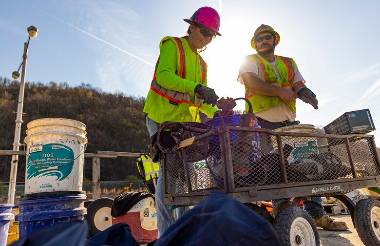 Hannah Hamer, a cement mason apprentice, mixes mortar while Matt Wilson, a laborer, gets ready to work a torch at a construction site for the new river chamber at the Monongahela River Locks and Dam 4 in Charleroi, Pennsylvania, April 12, 2023.

The U.S. Army Corps of Engineers Pittsburgh District hosted the tour and several briefings about ongoing and future inland navigation construction projects within the district.

During the tour, Inland Waterways User Board (IWUB) members learned about the overall Lower Monongahela River navigation project and the new river chamber construction at Charleroi, which is in its final phase after nearly 20 years of construction. Members also listened to briefings about the overall Upper Ohio navigation project and its first major construction contract, the new Montgomery lock construction. 

IWUB is an industry federal-advisory committee representing all fuel-taxed inland waterway systems within the United States. The navigation industry contributes to the Inland Waterways Trust Fund through fuel taxes paid by carriers who transport bulk commodities on the inland waterway system. The board makes recommendations to Congress and the Assistant Secretary of the Army for Civil Works on how best to invest federal and trust funds dollars to keep the most cost-effective, environmentally friendly, and safest form of transportation for bulk commodities resilient and reliable.
(U.S. Army Corps of Engineers Pittsburgh District photo by Michel Sauret)