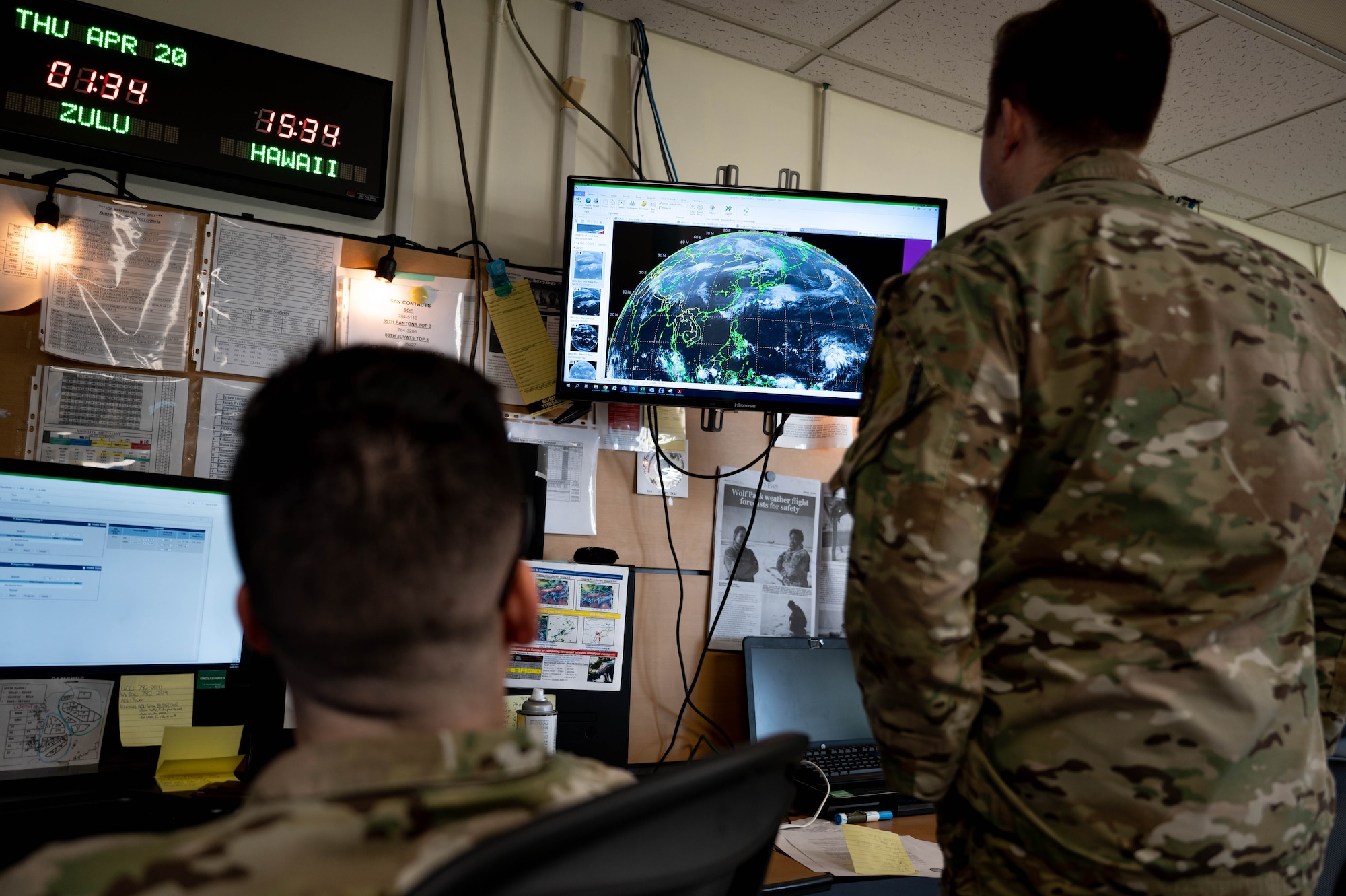 Staff Sgt. Kaleb Schmidt (left) and 1st Lt. Keis Verleur (right), 8th Operations Support Squadron weather forecasters, analyze satellite imagery at Kunsan Air Base, Republic of Korea, April 20, 2023.