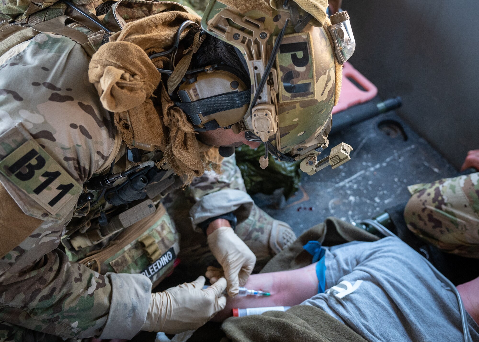 A Pararescue Specialist with the 52nd Expeditionary Rescue Squadron inserts an IV catheter into a simulated injured patient while inside an HH-60G Pave Hawk helicopter at an undisclosed location in Southwest Asia, March 13, 2023.