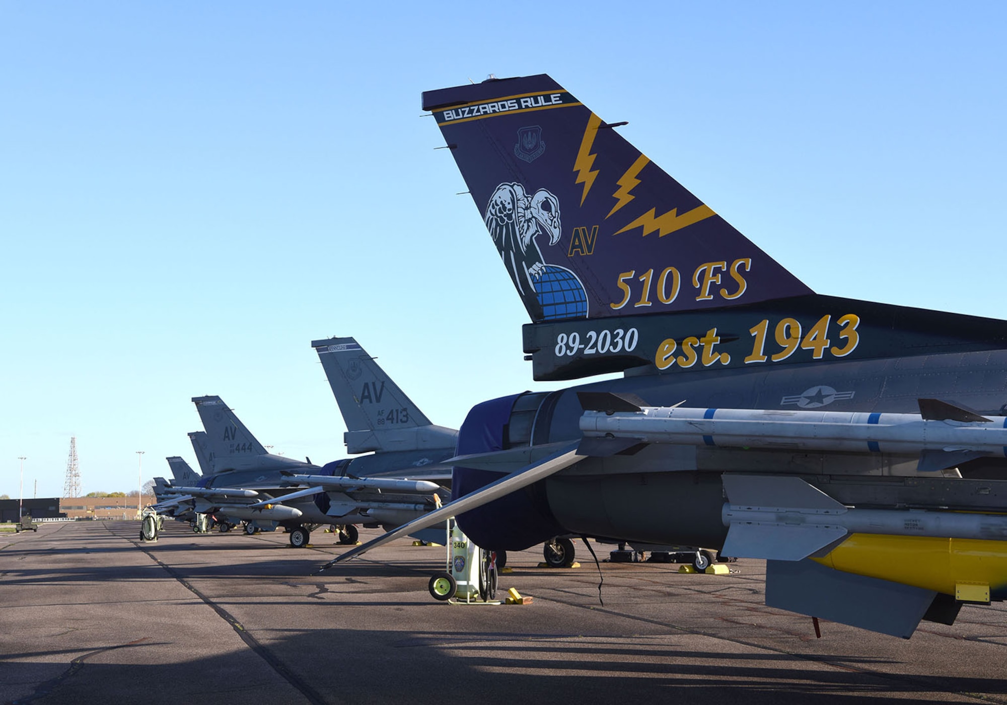 U.S. Air Force F-16CM Fighting Falcons from the 510th Fighter Squadron, Aviano Air Base, Italy, sit on the flightline before being prepped for takeoff at Royal Air Force Mildenhall, England, April 12, 2023. The 510th FS, known as “Buzzards,” provides combat airpower on demand to U.S. and NATO combatant commanders, as well as the National Command Authority in order to meet National Security objectives. The unit performs air and space control and force application roles of counter-air, strategic attack, and counter-land including interdiction and close-air support. (U.S. Air Force photo by Karen Abeyasekere)