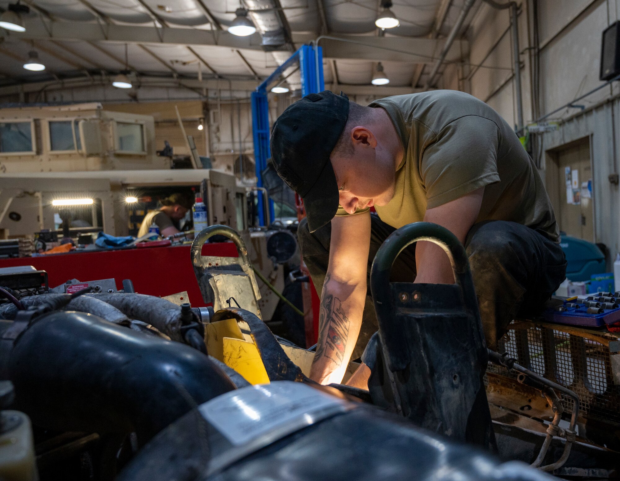 U.S. Air Force Airman 1st Class Chase VanCleave, a 386th Expeditionary Logistics Readiness Squadron vehicle and vehicular equipment technician, works on the fan clutch of a humvee at Ali Al Salem Air Base, Kuwait, April 10, 2023.