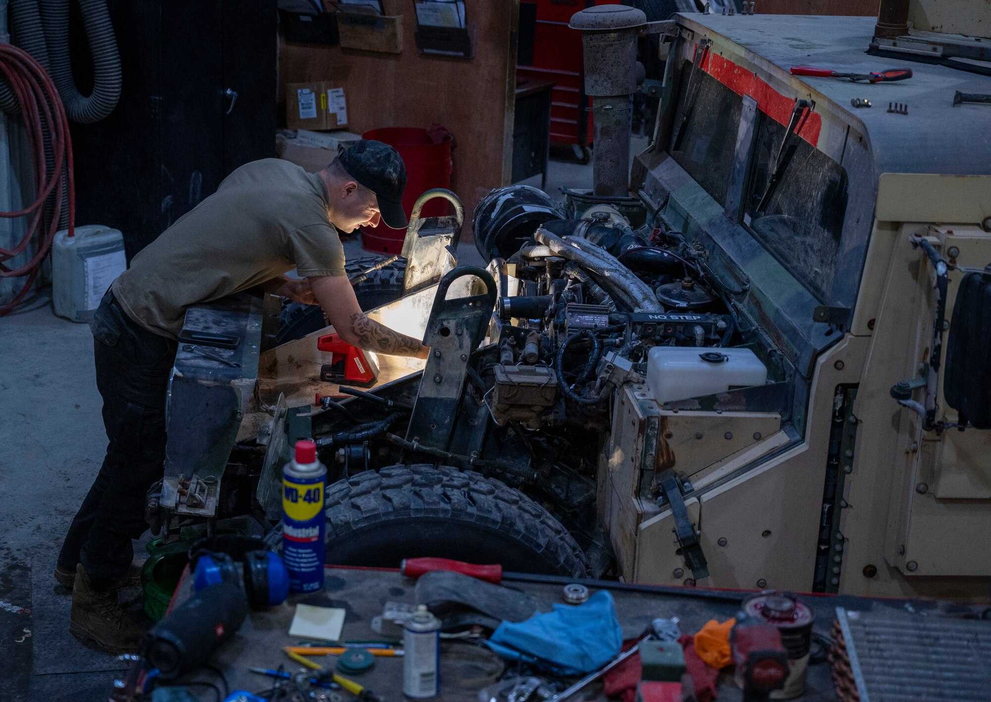 U.S. Air Force Airman 1st Class Chase VanCleave, a 386th Expeditionary Logistics Readiness Squadron vehicle and vehicular equipment technician, works on the fan clutch of a humvee at Ali Al Salem Air Base, Kuwait, April 10, 2023.