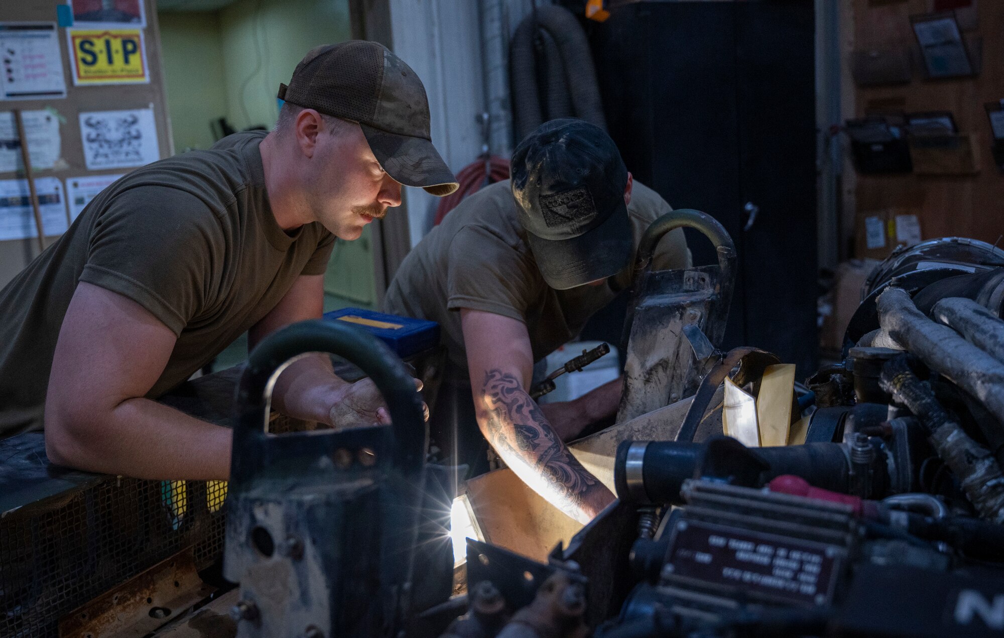 U.S. Air Force Airmen 1st Class Caleb Cearley and Chase VanCleave, 386th Expeditionary Logistics Readiness Squadron vehicle and vehicular equipment technicians, work on the fan clutch of a Humvee at Ali Al Salem Air Base, Kuwait, April 10, 2023.
