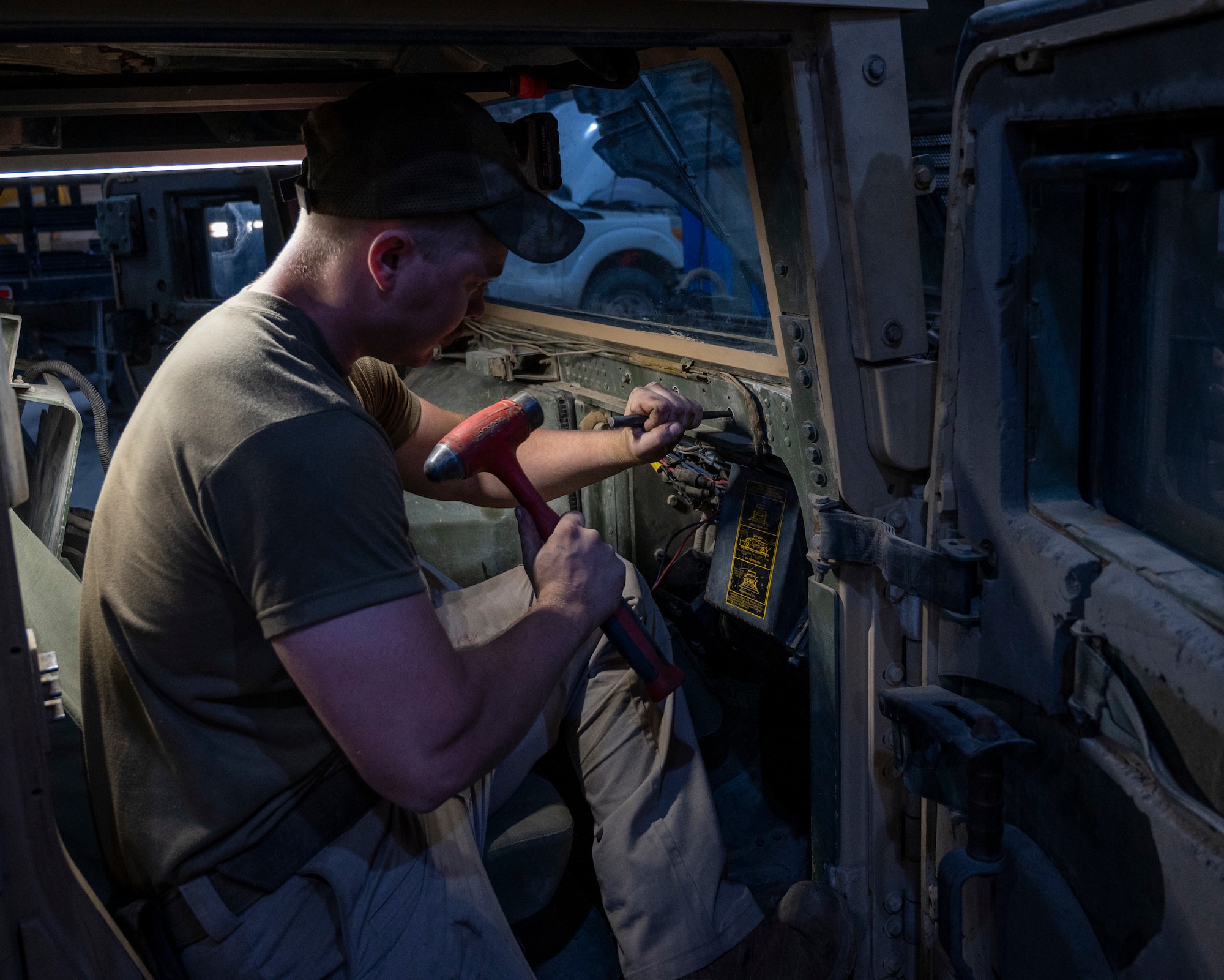 U.S. Air Force Airman 1st Class Caleb Cearley, a 386th Expeditionary Logistics Readiness Squadron vehicle and vehicular equipment technician, works on the air conditioning molding of a Humvee at Ali Al Salem Air Base, Kuwait, April 10, 2023.