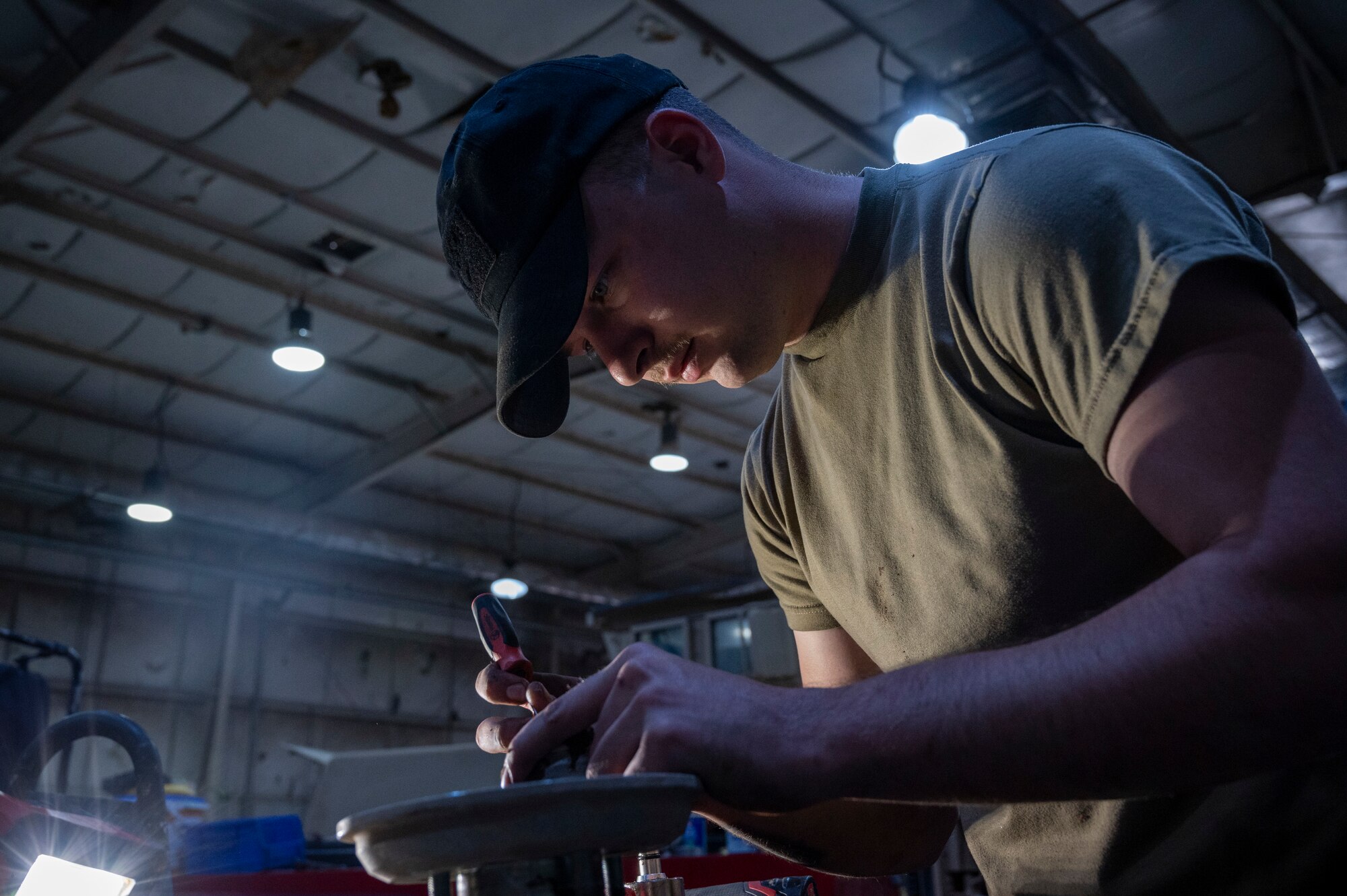 U.S. Air Force Airman 1st Class Chase VanCleave, a 386th Expeditionary Logistics Readiness Squadron vehicle and vehicular equipment technician, works on the fan clutch of a Humvee at Ali Al Salem Air Base, Kuwait, April 10, 2023.