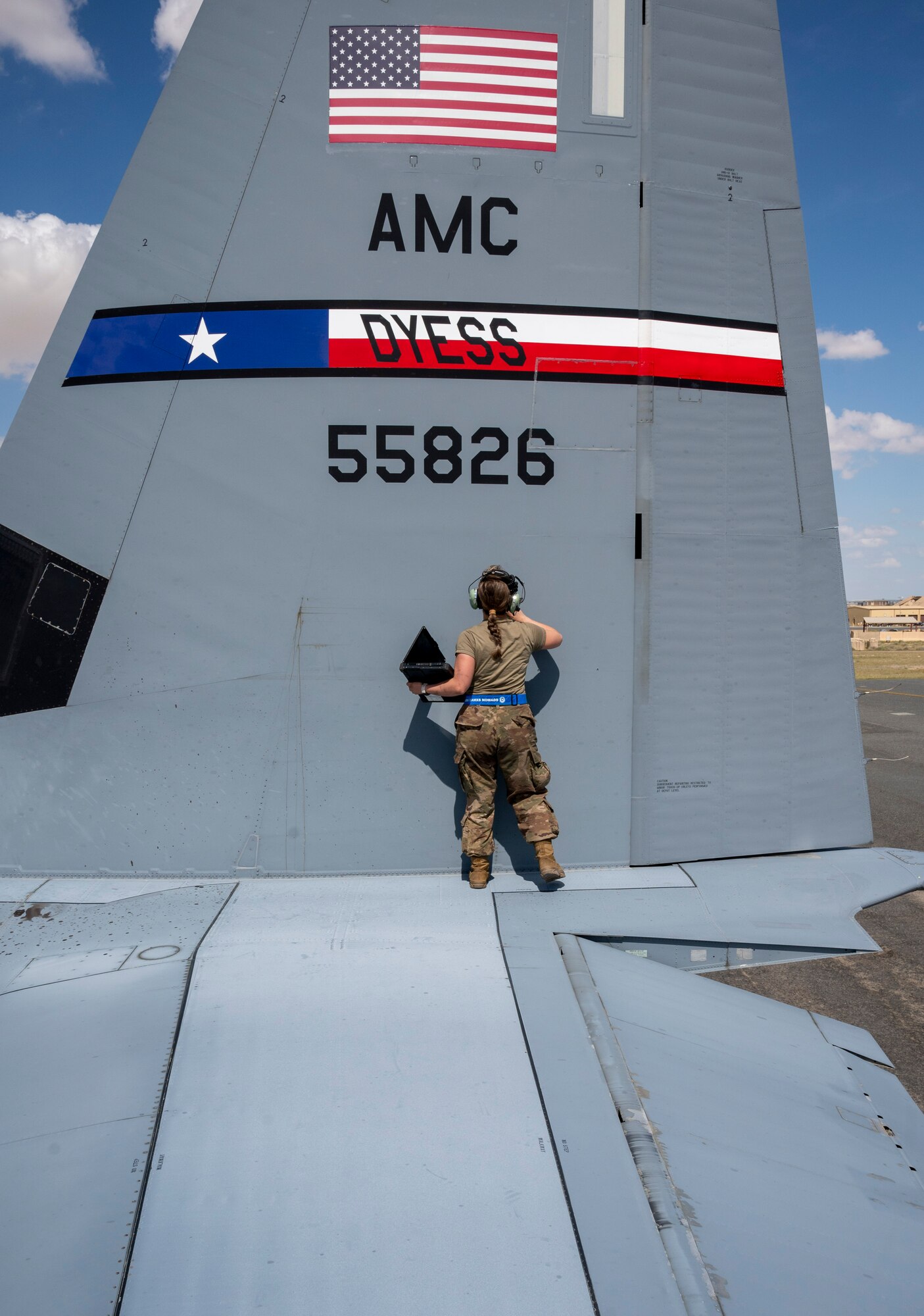 U.S. Air Force Airman Taylor Howard, 386th Expeditionary Aircraft Maintenance Squadron crew chief, inspects the vertical stabilizer of a C-130J Super Hercules at Ali Al Salem Air Base, Kuwait, March 22, 2023.