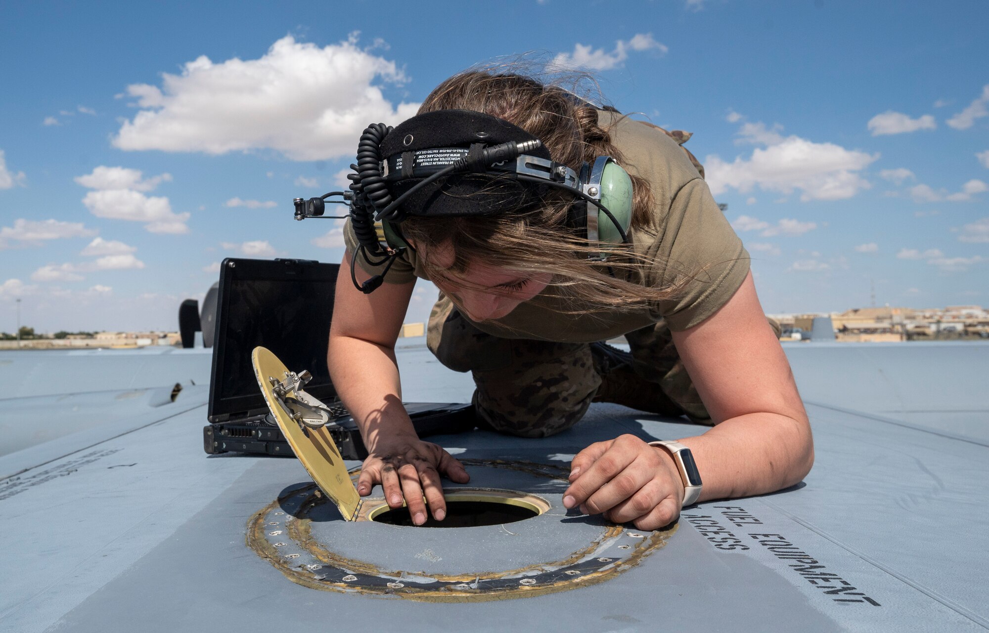 U.S. Air Force Airman Taylor Howard, a 386th Expeditionary Aircraft Maintenance Squadron crew chief, inspects the fuel equipment access point of a C-130J Super Hercules at Ali Al Salem Air Base, Kuwait, March 22, 2023.