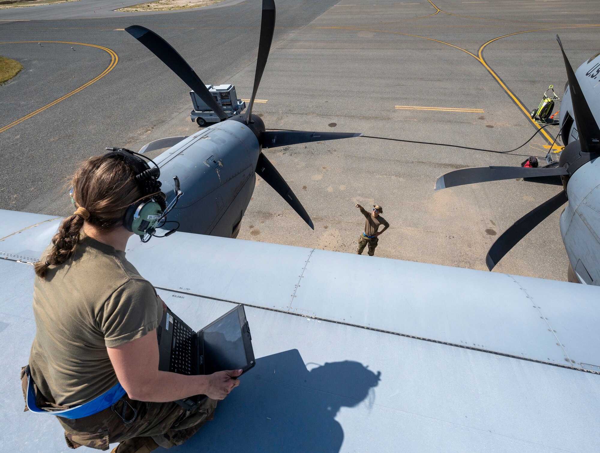 U.S. Air Force Senior Airman Tyler Horschel and Airman Taylor Howard, 386th Expeditionary Aircraft Maintenance Squadron crew chiefs, inspect the wing of a C-130J Super Hercules at Ali Al Salem Air Base, Kuwait, March 22, 2023.