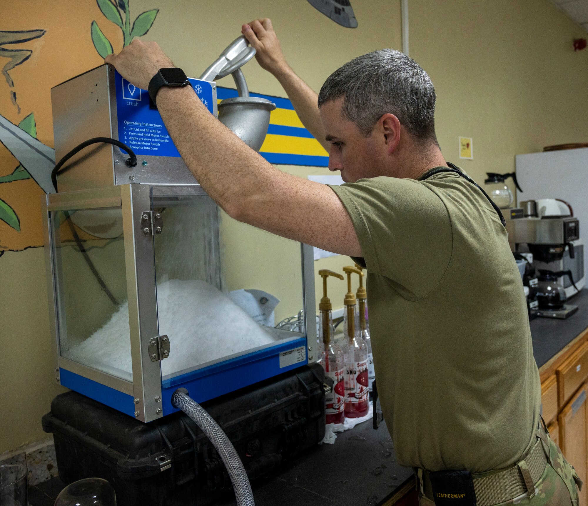 U.S. Air Force Master Sgt. Jeremy Call, 386th Air Expeditionary Wing chaplain assistant, makes shaved ice for snow cones at Ali Al Salem Air Base, Kuwait, April 19, 2023