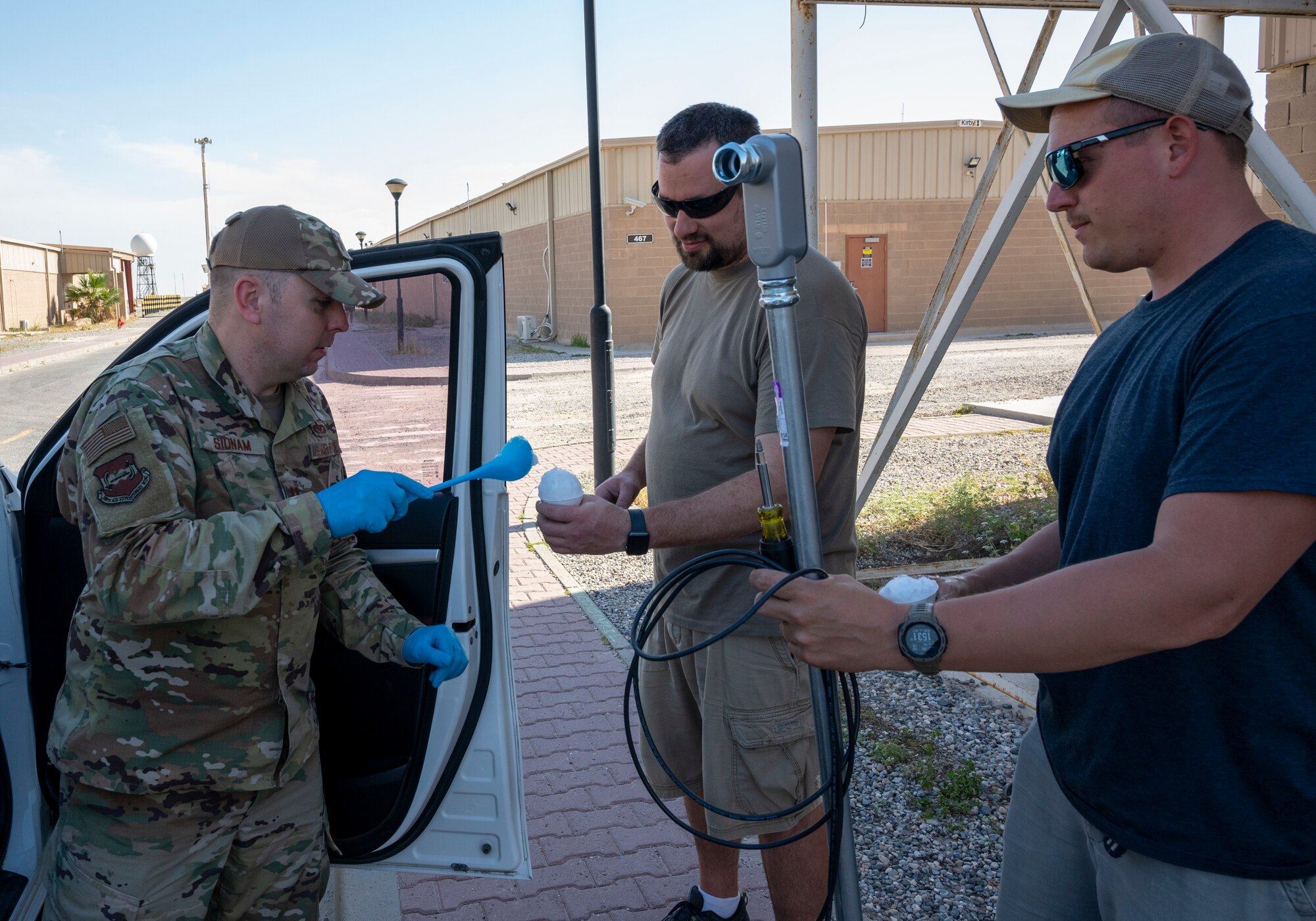 U.S. Air Force Capt. David Sidnam, a 386th Air Expeditionary Wing chaplain, gives snow cones to Marauders at Ali Al Salem Air Base, Kuwait, April 19, 2023.
