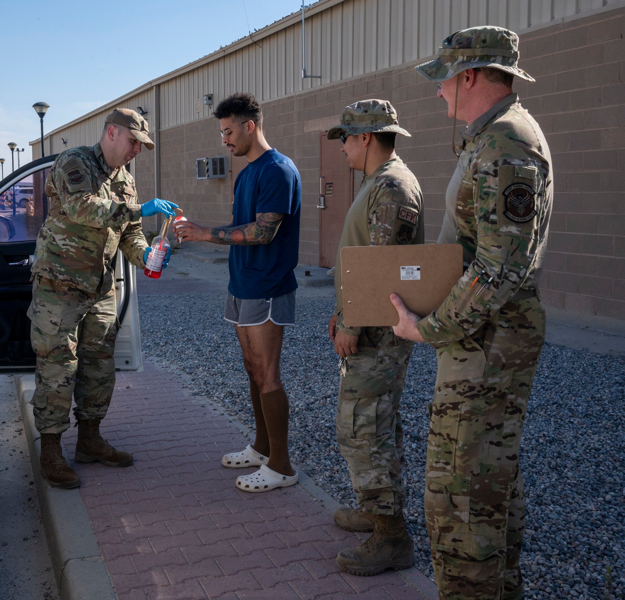 U.S. Air Force Capt. David Sidnam, a 386th Air Expeditionary Wing chaplain, gives snow cones to Airmen at Ali Al Salem Air Base, Kuwait, April 19, 2023.