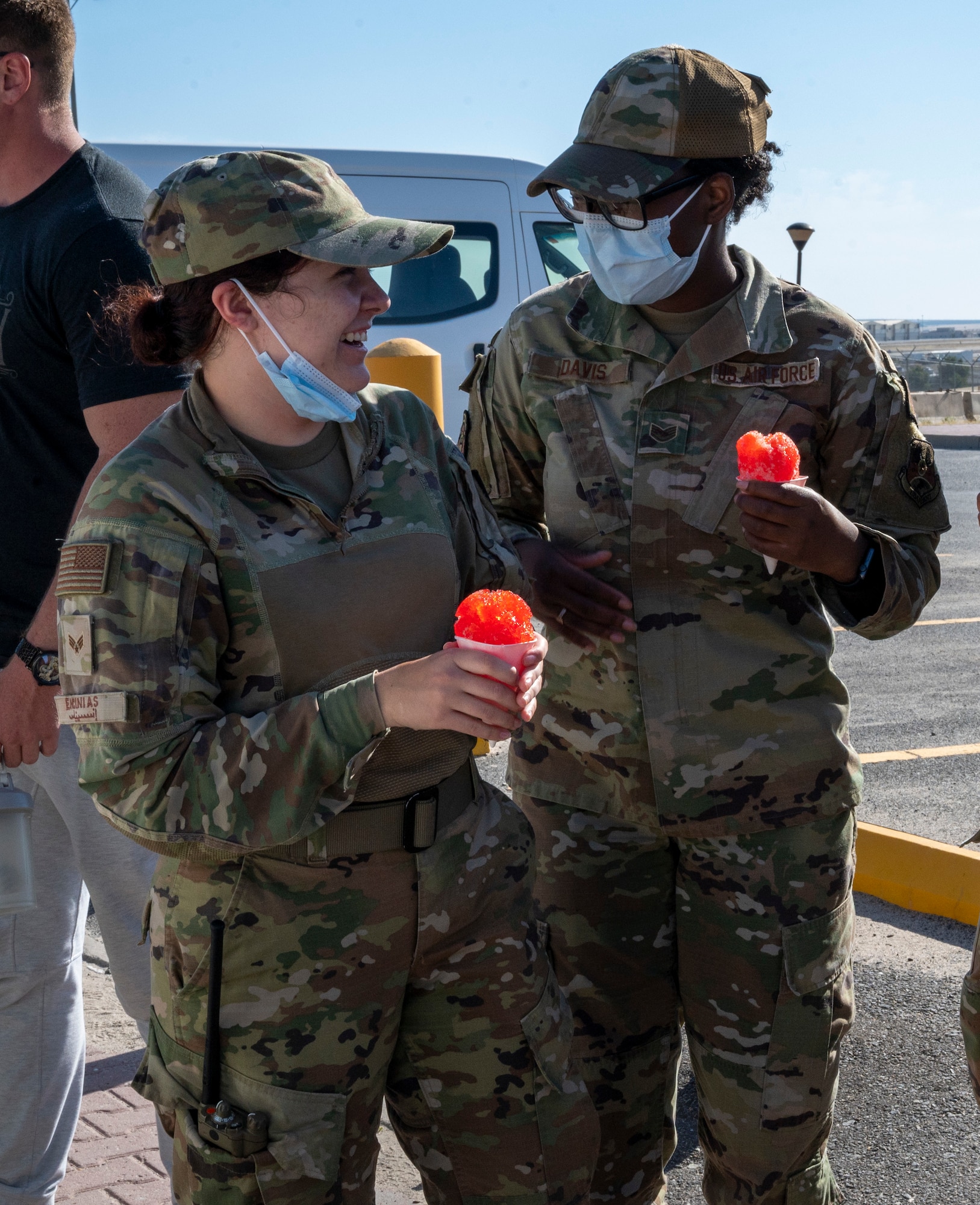 U.S. Air Force Senior Airman Sarah Encinias and Staff Sgt. Marquisha Davis, 386th Expeditionary Medical Readiness Squadron technicians, enjoy snow cones at Ali Al Salem Air Base, Kuwait, April 19, 2023.
