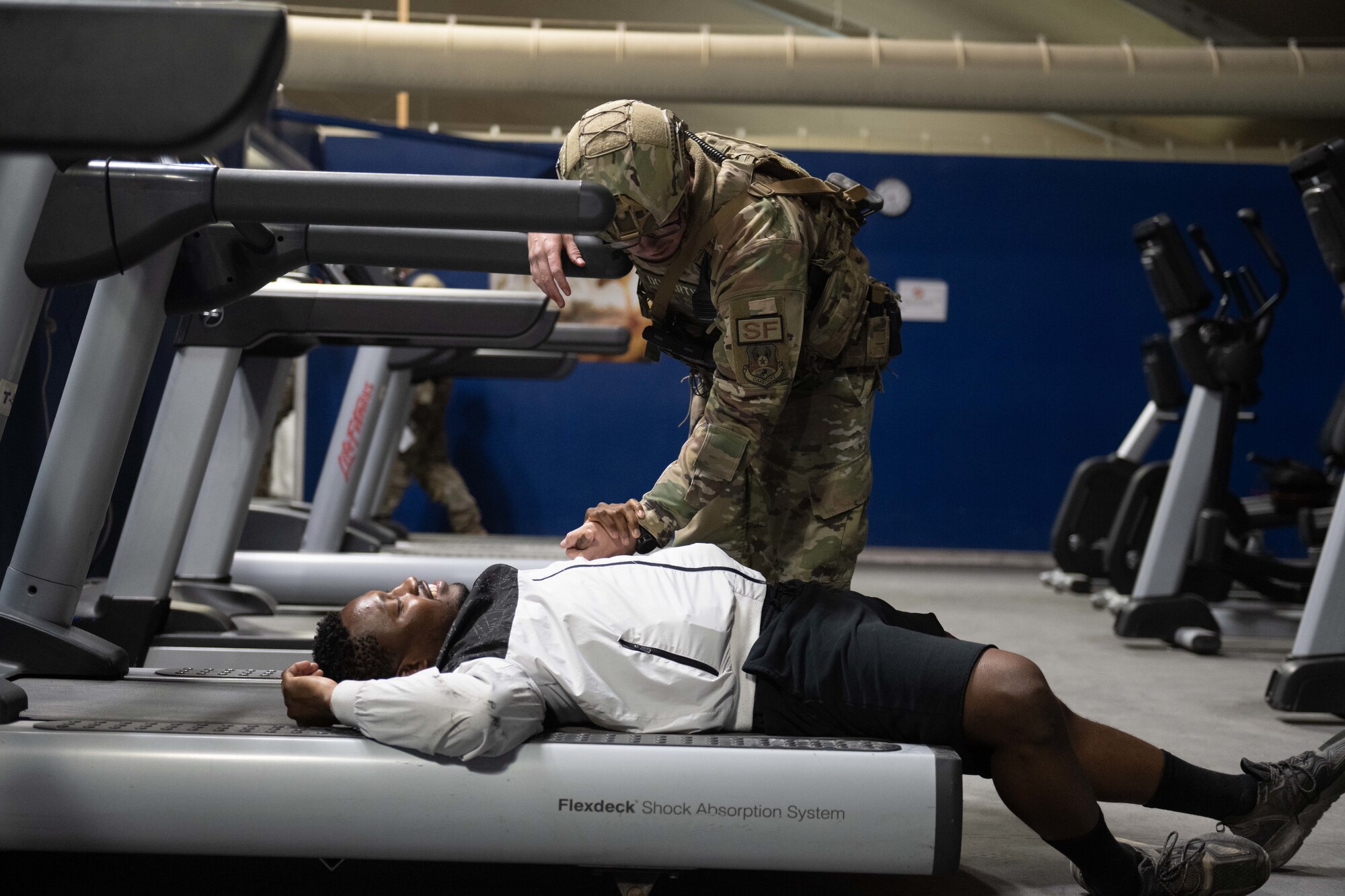 Tech. Sgt. Kenneth Doherty from the 332d Expeditionary Security Forces Squadron checks on a simulated wounded member during a mass casualty exercise at an undisclosed location in Southwest Asia, March 13, 2023.