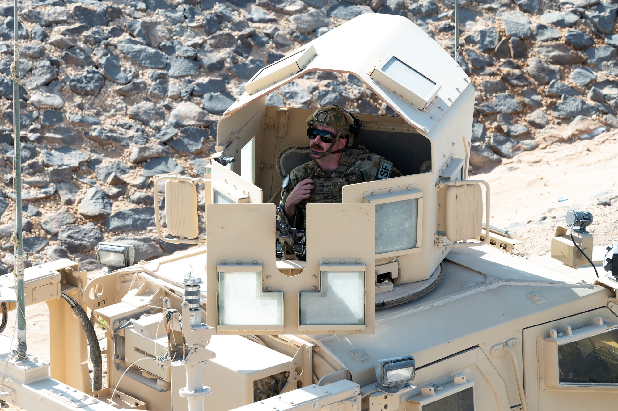 A U.S. Air Force Airman assigned to the 332d Expeditionary Security Forces Squadron patrols the base in a Mine-Resistant Ambush Protected All-Terrain Vehicle during a mass casualty training scenario at an undisclosed location in Southwest Asia, March 13, 2023.
