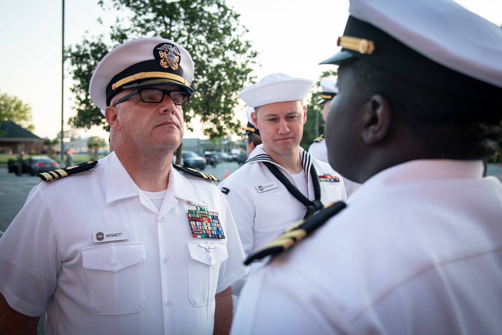 Lt. Cmdr. Carlton Bennett, left, inspects the Summer Whites uniform of Navy Lt. William Hookes Jr., right, as Hospital Corpsman Second Class Nathan Zachreus takes notes during a Summer Dress White inspection Thursday, April 20, 2023 aboard Marine Corps Air Station Cherry Point, North Carolina.  

The inspection provided Sailors serving aboard Naval Health Clinic Cherry Point an opportunity to participate in a Navy tradition, demonstrate attention to detail and celebrate the coming summer season.