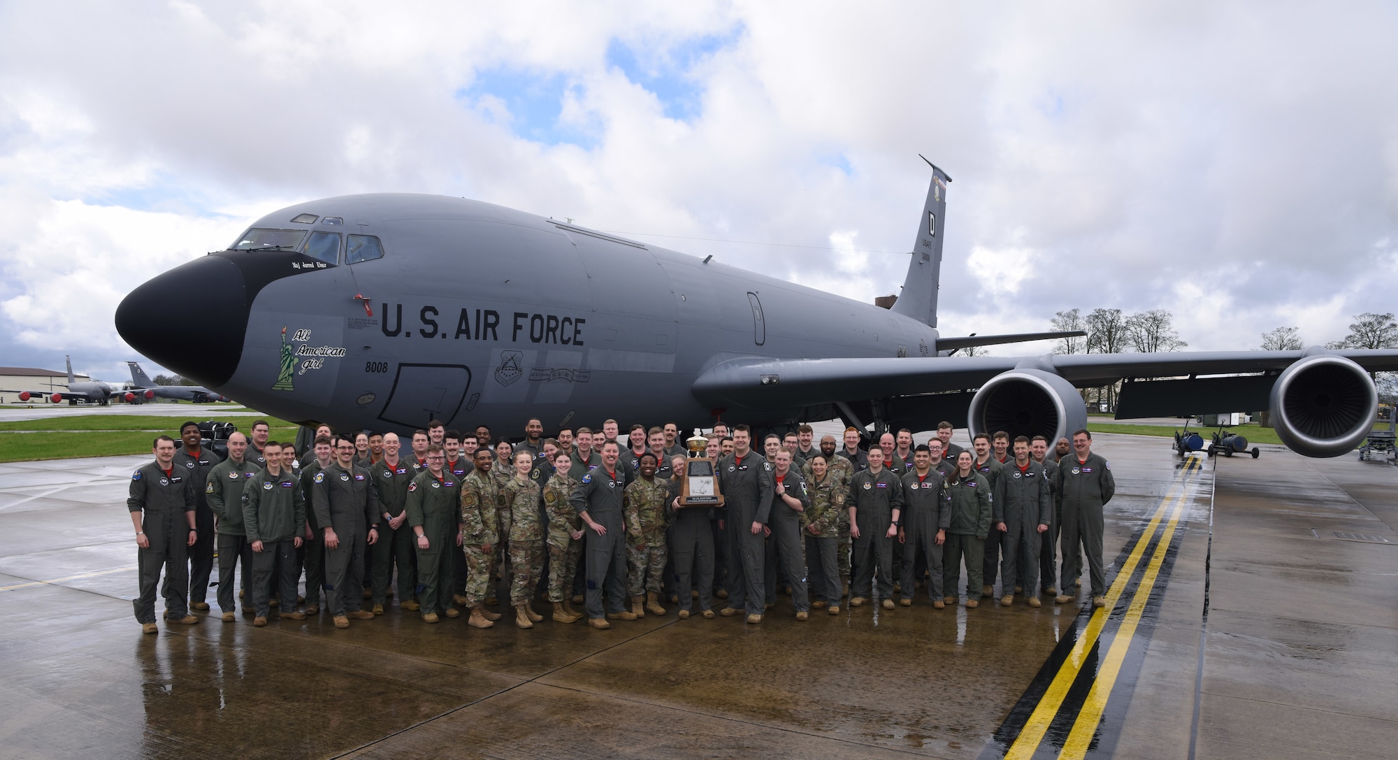 U.S. Air Force Airmen from the 351st Air Refueling Squadron show off their hard-won trophy for being “Best in Air Force” at Royal Air Force Mildenhall, England, March 31, 2023. The 351st ARS earned the Gen. Carl A. Spaatz Trophy as the “Outstanding Air Refueling Squadron,” rating Number 1 out of 59 air refueling squadrons within the U.S. Air Force. The achievements that won them the award include executing 1,382 missions with 8,064 flying hours in 2022, and ensuring 7,000 man-hours of non-stop, Joint Chiefs of Staff-directed alerts over four consecutive months. (U.S. Air Force photo by Karen Abeyasekere)