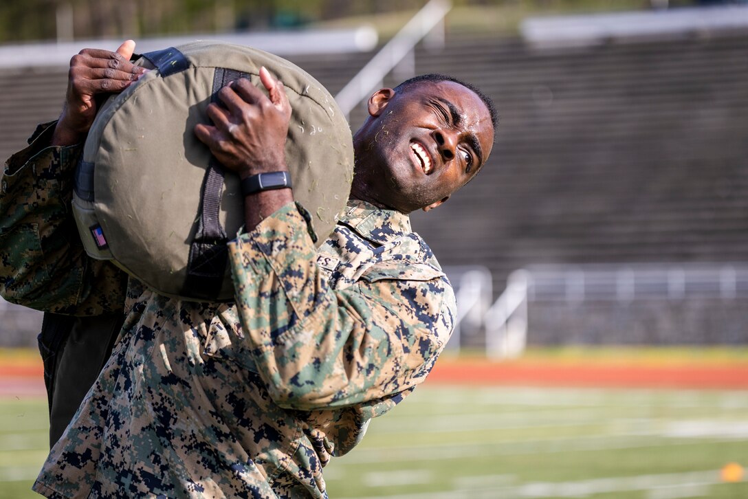 U.S. Marine Corps Sgt. Walter P. Thomas, a motor transportation instructor with Marine Corps Training Battalion, Fort Leonard Wood, Missouri, carries a 150-pound sandbag as part of the “Gas Can” event during the first Training Education Command Fittest Instructor Competition on Marine Corps Base Quantico, Virginia, April 12, 2023. The “Gas Can” event is a non-stop combat fitness test designed to push even the fittest Marines to their limit.  (U.S. Marine Corps photo by James Frank)