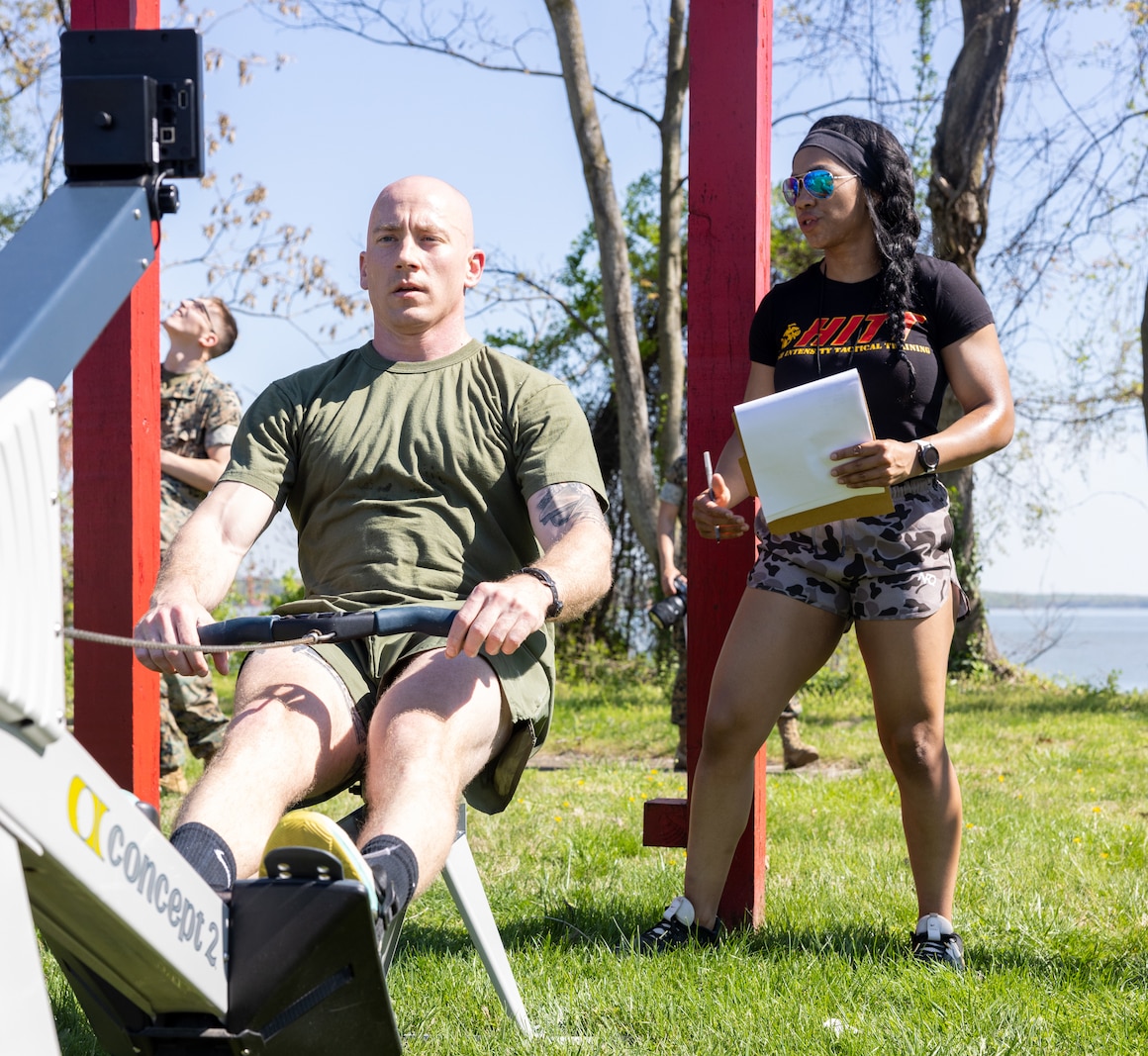 U.S. Marine Corps Capt. Stephen Dukes, an instructor with U.S. Naval Justice School, Newport, Rhode Island, uses the rowing machine during the flight school event during the first Training and Education Command Fittest Instructor Competition on Marine Corps Base Quantico, Virginia, April 13, 2023. Marines had a time limit of thirty minutes to complete a maximum of ten rounds of rowing and pull-ups. (U.S. Marine Corps photo by Lance Cpl. Jeffery Stevens)