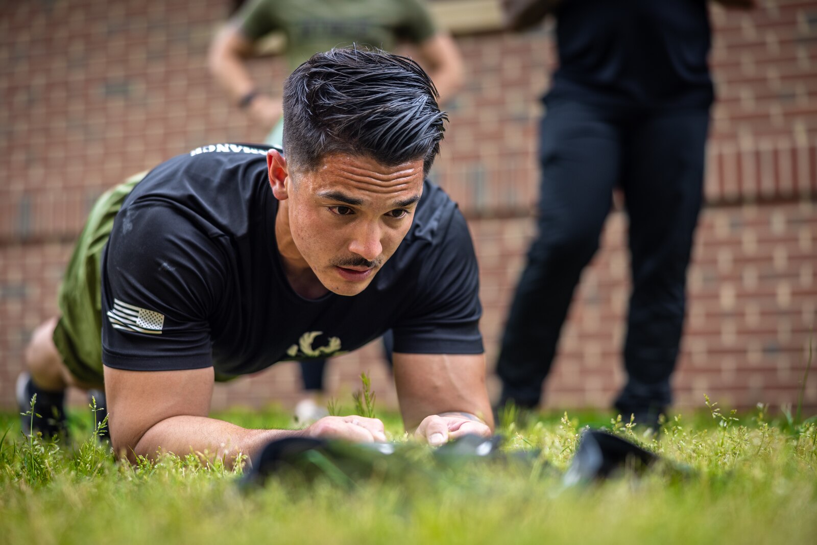 U.S. Marine Corps Staff Sgt. John Schmitt, a combat instructor with the School of Infantry-East Combat Instructor School, holds a plank during the “Prevention” event while participating in the first Training and Education Command Fittest Instructor Competition on Marine Corps Base Quantico, Virginia, April 14, 2023. Marines had nine minutes to complete as many repetitions as possible of thrusters and wall walks. (U.S. Marine Corps photo by Lance Cpl. Joaquin Dela Torre)
