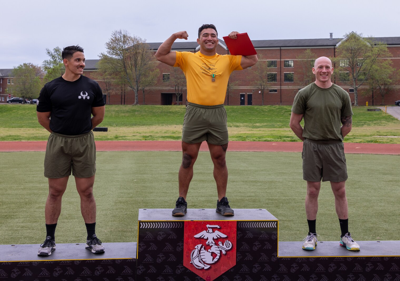 From left to right, U.S. Marine Corps Staff Sgt. John E. Schmitt, an instructor with School of Infantry East, Camp Lejeune, North Carolina, Sgt. Christopher J. Martin, an instructor with Marine Combatant Dive Detachment, Marine Aviation Training Support Group 21, Panama City, Florida, and Capt. Stephen W. Dukes, an instructor with the U.S. Naval Justice School, Newport, Rhode Island, pose for a photo during the awards ceremony for the first Training Education Command Fittest Instructor Competition on Marine Corps Base Quantico, Virginia, April 14, 2023. The competitors underwent four days of competition that pushed each of them to their physical and mental limits. They learned that fitness is a skill that needs to be learned, practiced and maintained. (U.S. Marine Corps Photo by Lance Cpl. Kayla LeClaire)