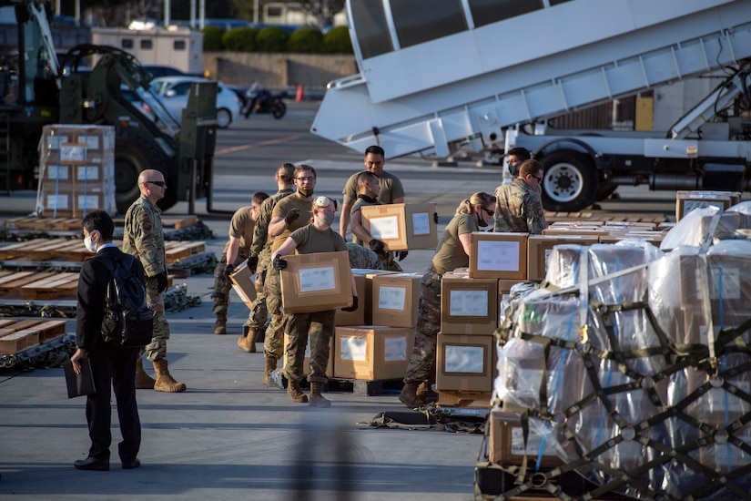 People carry boxes.