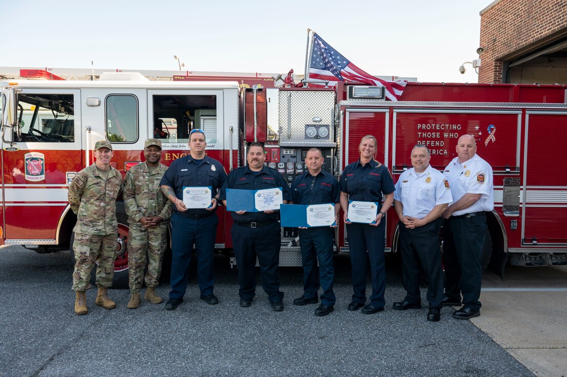 Life Saving and Significant Achievement Award recipients pose for a photo with leaders from the 11th Wing and Naval District Washington Fire and Emergency Services at the Life Saving Award presentation, April 13, 2023, Joint Base Anacostia-Bolling, Washington, D.C. Members of NDWFES were recognized with Certificates of Life Saving and Significant Achievement for their quick response to an incident on JBAB which resulted in the patient’s second chance at life. (U.S. Air Force photo by Kristen Wong)