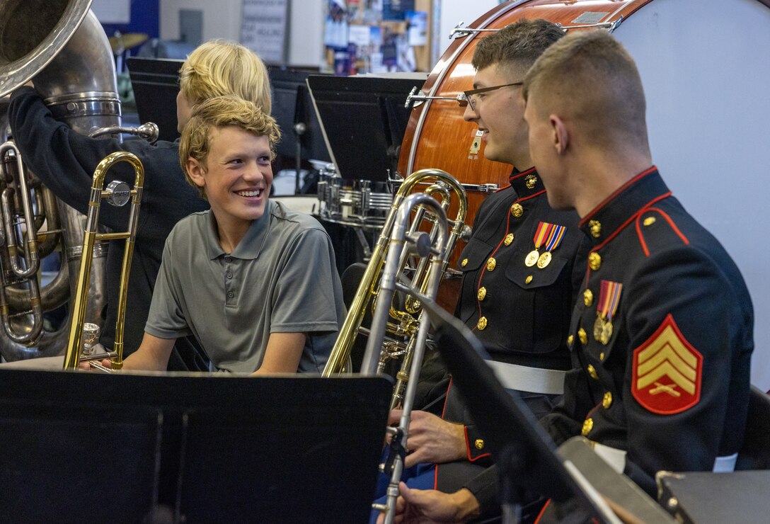 U.S. Marines with the Quantico Marine Corps Band talk to students with the band at Norfolk Christian Schools in Norfolk, Virginia, April 17, 2023. The Marines assisted students by integrating into each instrumental section and playing alongside them in order to strengthen their musical skills. (U.S. Marine Corps Photo by Lance Cpl. Kayla LeClaire)