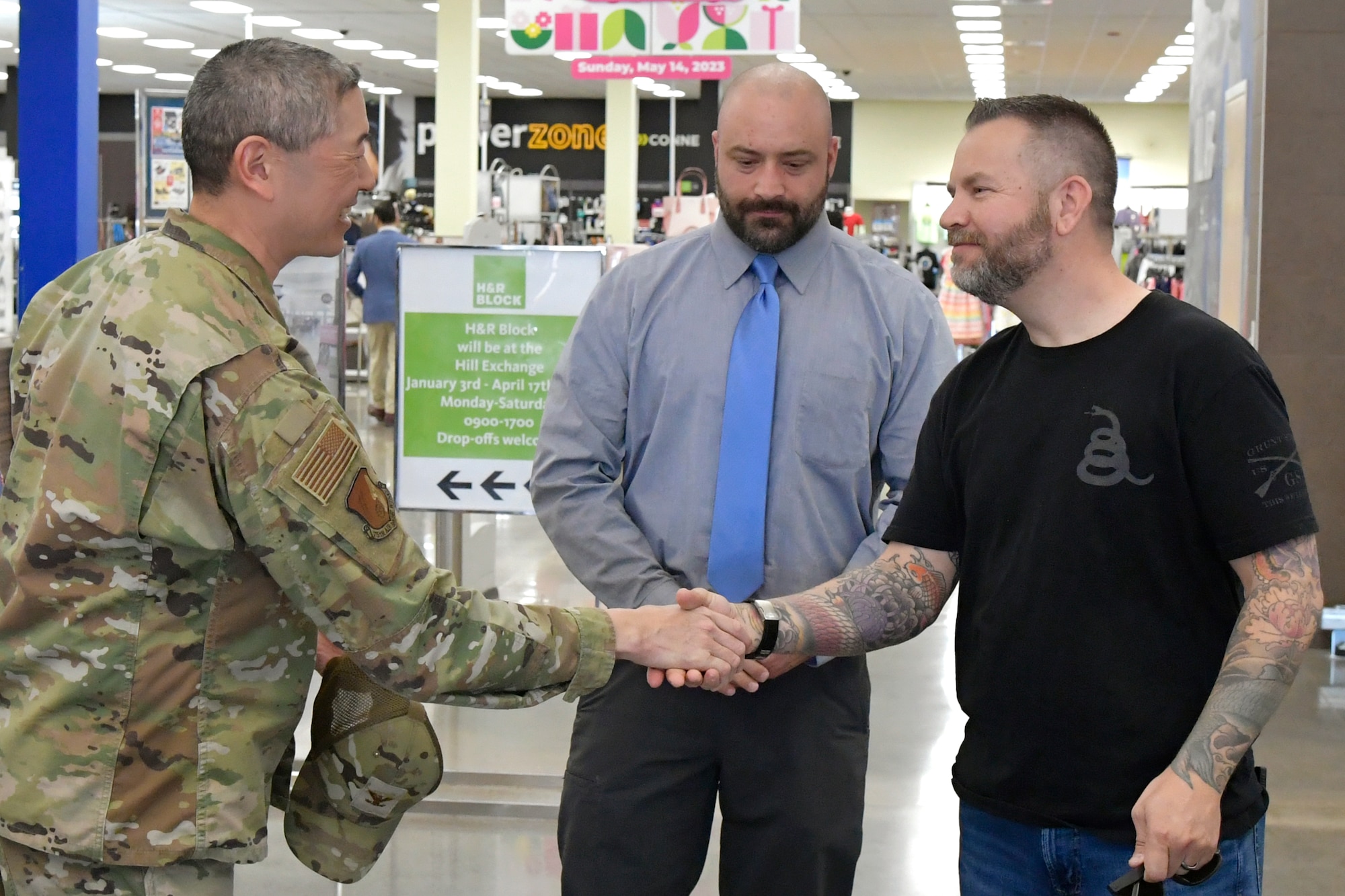 Right, Christopher Marks, Air Force Test Center, accepts a coin from Col. Peter Feng, vice commander, 75th Air Base Wing, for his submission to the Holocaust Days of Remembrance art exhibit April 17, 2023, at Hill Air Force Base, Utah.