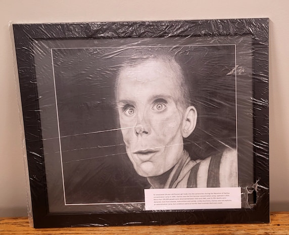 An emaciated 18-year-old Russian girl looks into the camera lens during the liberation of Dachau concentration camp in 1945. (Drawing by Alissa Atkinson)
