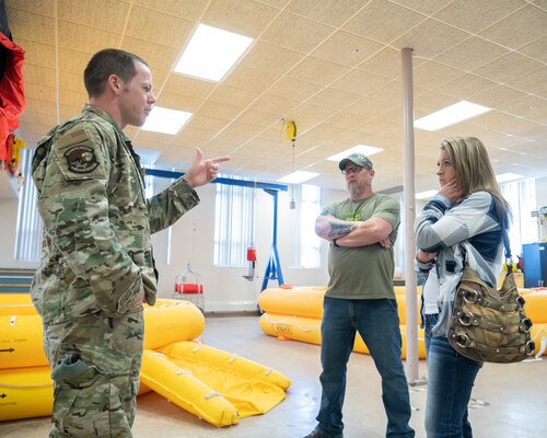 Tech. Sgt. Derrick Day, 436th Operations Support Squadron survival, evasion, resistance and escape operations flight chief, gives former prisoners of war Jessica Lynch and Patrick Miller a tour of the SERE training facility at Dover Air Force Base, Delaware, April 18, 2023. During their visit, Lynch and Miller toured the base and spoke about their experiences as POWs. (U.S. Air Force photo by Mauricio Campino)