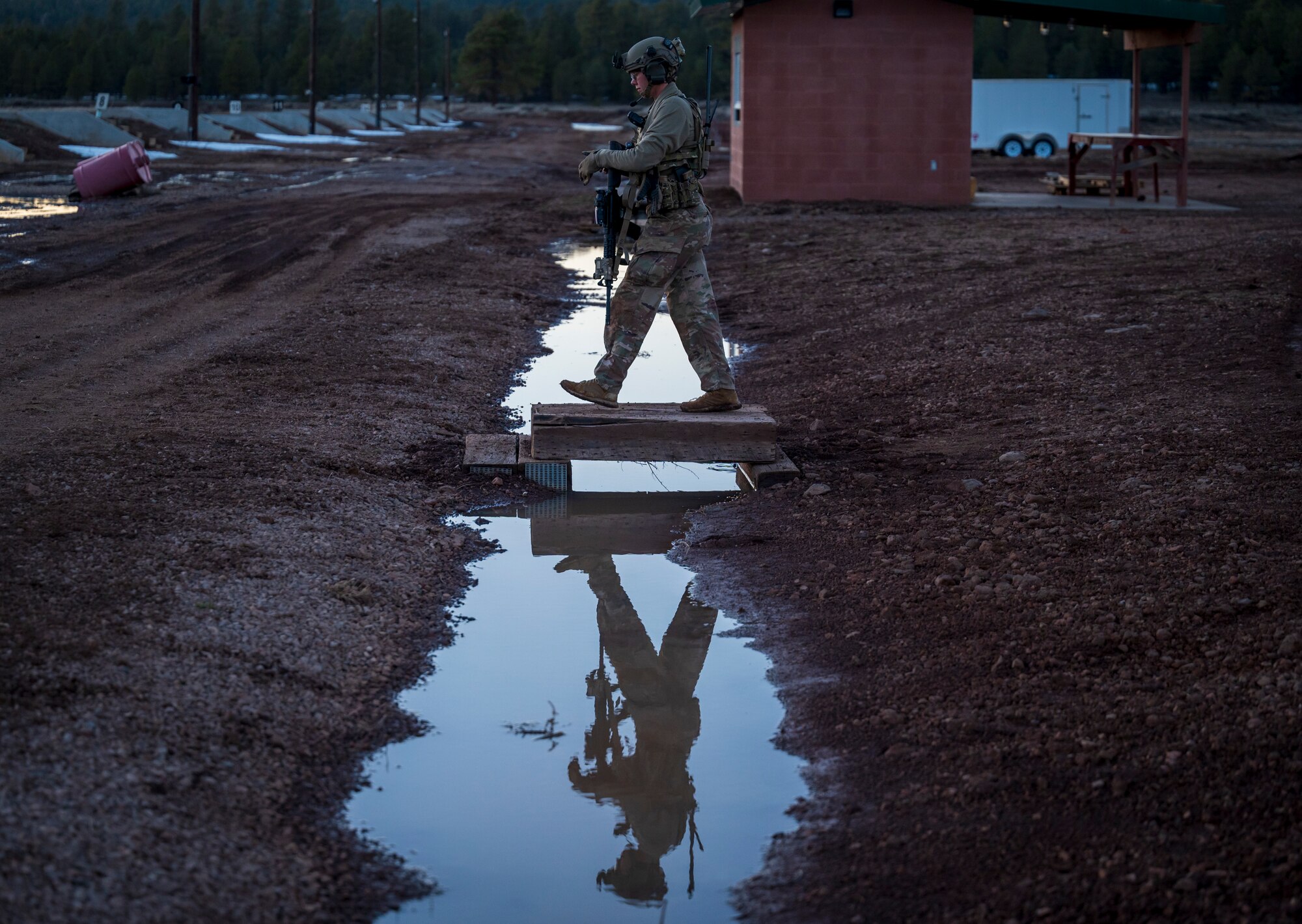 U.S. Air Force Airman First Class Brianna Mclain, 56th Civil Engineer Squadron Explosive Ordnance Disposal flight technician, walks across a platform on a firing range at Camp Navajo, Arizona, April 10, 2023.