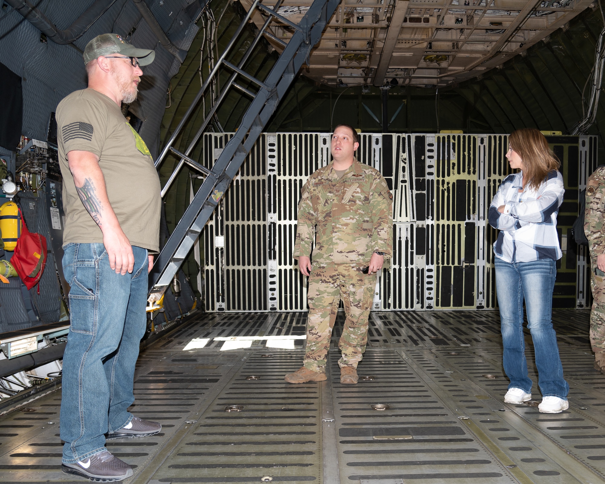 Tech. Sgt. Justin Marriott, 9th Airlift Squadron noncommissioned officer in charge of loadmaster training, gives former prisoners of war Jessica Lynch and Patrick Miller a tour of a C-5M Super Galaxy at Dover Air Force Base, Delaware, April 18, 2023. During their visit, Lynch and Miller toured the base and spoke about their experiences as POWs. (U.S. Air Force photo by Mauricio Campino)