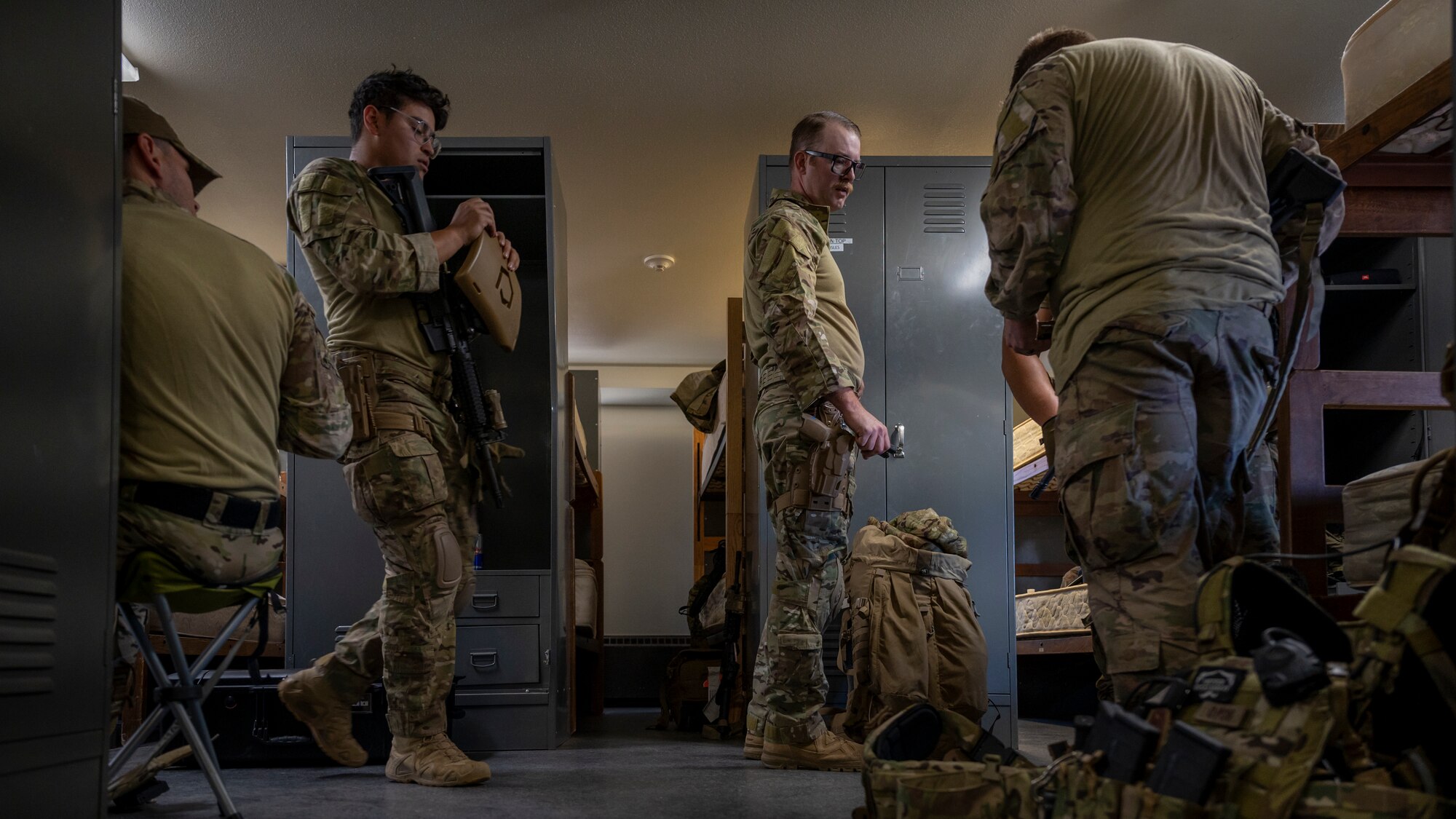 Members assigned to the 56th Civil Engineer Squadron Explosive Ordnance Disposal flight prepare gear in a barracks at Camp Navajo, Arizona, April 10, 2023.