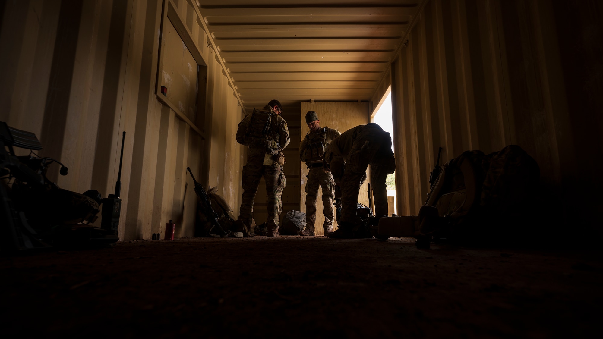 U.S. Air Force Airmen assigned to the 56th Civil Engineer Squadron Explosive Ordnance Disposal flight, prepare to leave a mock village to investigate the surrounding area during a training scenario at Camp Navajo, Arizona, April 12, 2023.