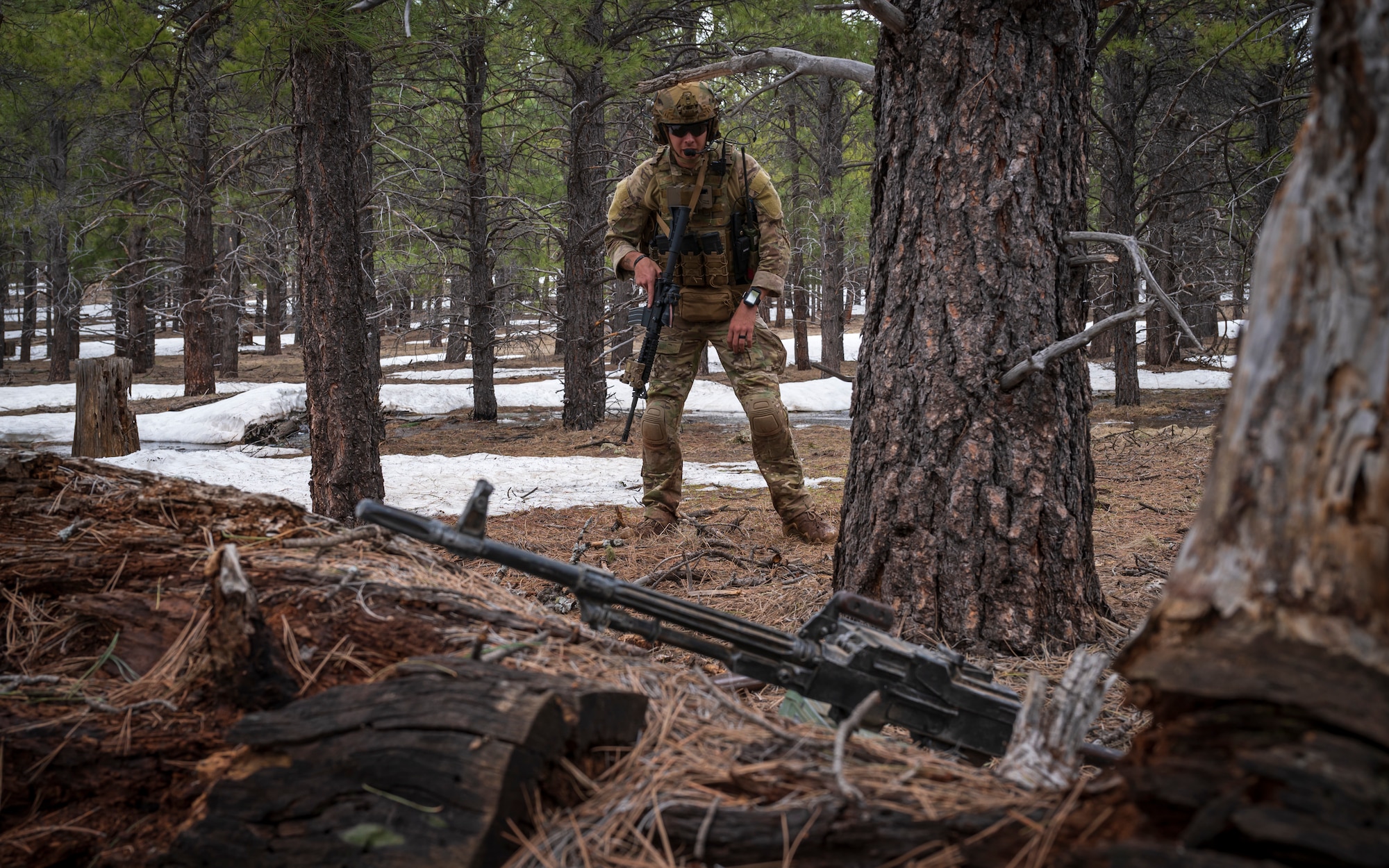 U.S. Air Force Tech. Sgt. Tyler Paul, 56th Civil Engineer Squadron Explosive Ordnance Disposal flight technician, investigates weapons that have been left behind outside a mock village during a training scenario at Camp Navajo, Arizona, April 12, 2023.